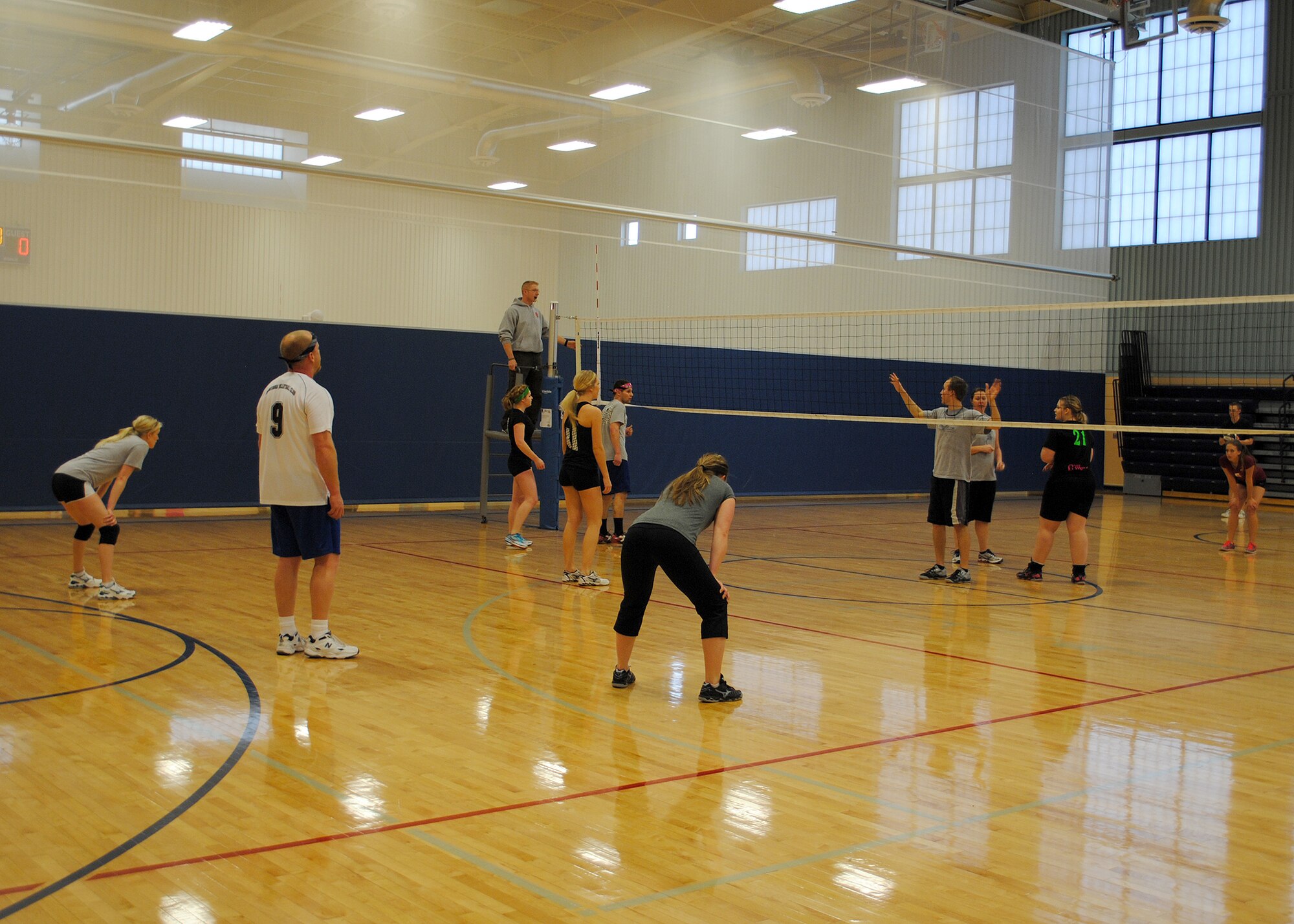 Members of the “Bandana Brigade” team prepare for offense before receiving a serve from their opponents “Grandpa’s Clothes” during the Ace in the Hole volleyball tournament held at the Malmstrom Fitness Center on Jan. 19.  Seven teams from base as well as local communities participated in the tournament.  (U.S. Air Force photo/Senior Airman Cortney Paxton)