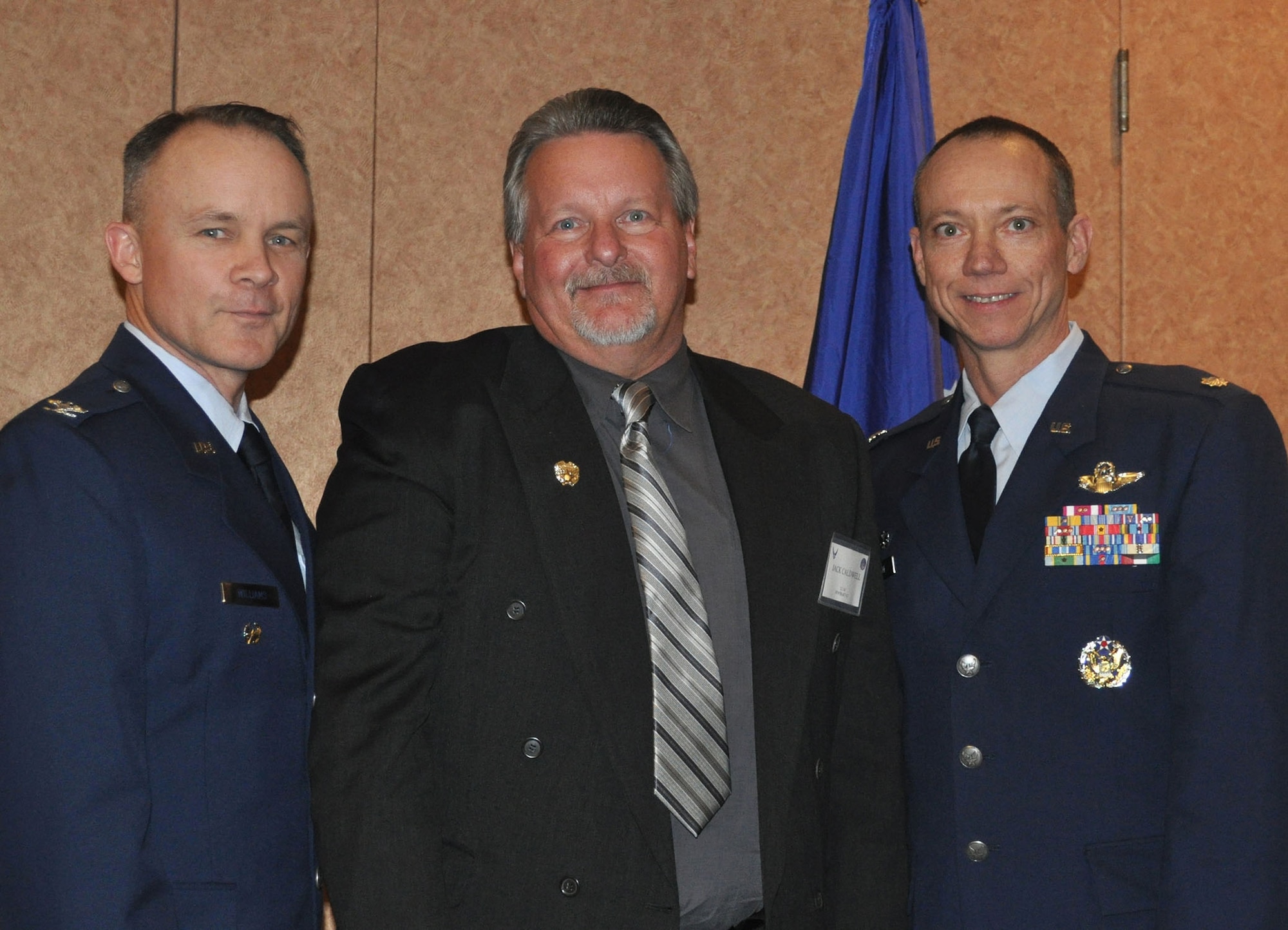 TRAVIS AIR FORCE BASE, Calif. -- Commanders welcomed new Honorary Commanders, Jan. 11, 2013. Here, Honorary Commander for the 312th Airlift Squadron, Mr. Jack Caldwell is welcomed by by Lt. Col. Kevin Lane, squadron commander, right, and 349th Air Mobility Wing Vice Commander, Col. John Williams, left. Caldwell is the local manager for Water Utility California Water Service Company, Dixon District. (U.S. Air Force photo/Senior Master Sgt. Ellen Hatfield)