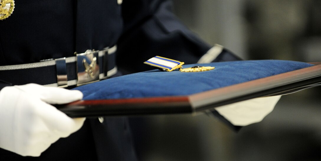 Staff Sgt. Ralph Morales, U.S. Air Force Honor Guard ceremonial guardsman, holds the U.S. Air Force Distinguished Service Medal prior to the medal presentation for Chief Master Sergeant of the Air Force James A. Roy during a transition ceremony at Joint Base Andrews, Md., Jan. 24, 2013. Chief Master Sgt. James A. Cody became the 17th CMSAF following the retirement of CMSAF James A. Roy. Roy's retirement culminated more than 30 years of service. (U.S. Air Force photo/ Staff Sgt. Nichelle Anderson)