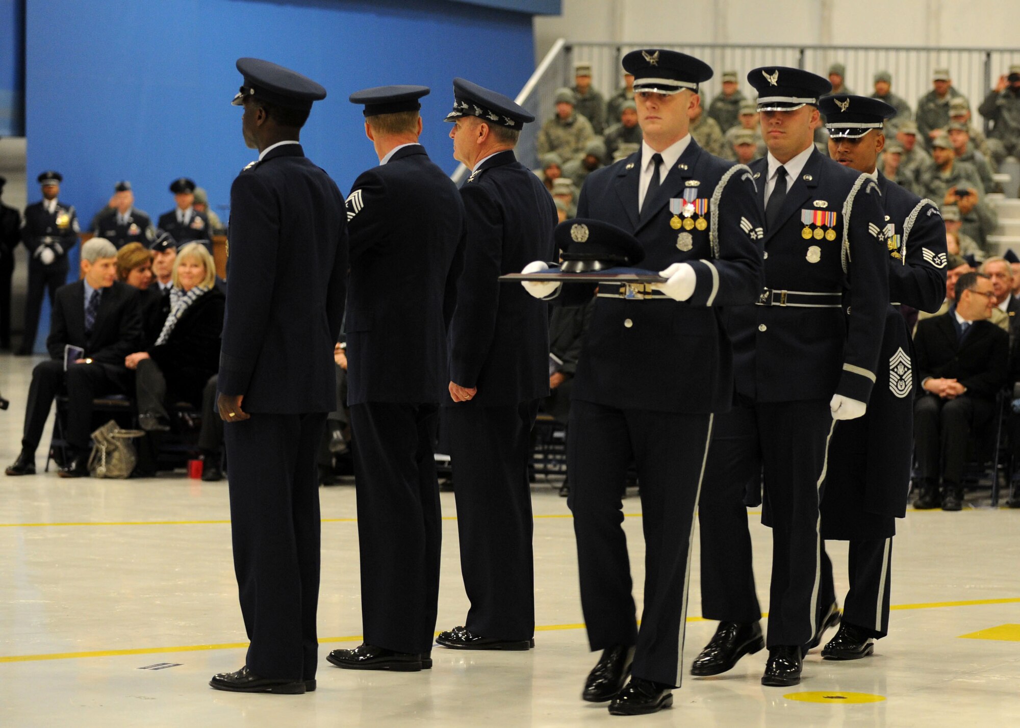 U.S. Air Force Honor ceremonial guardsmen Senior Airman Benjamin
Harris, Senior Airman Jeremy Dotson and Staff Sgt. Ralph Morales present
Chief Master Sgt. of the Air Force James Cody with his new hat and service
coat during a chief master sergeant of the Air Force transition ceremony at
Joint Base Andrews, Md., on Jan. 24, 2013. The U.S. Air Force Band and Honor
Guard honored the retiring Chief Master Sgt. of the Air Force James Roy and
welcomed new Chief Master Sgt. of the Air Force James Cody during the
ceremony. (U.S. Air Force photo/ Senior Airman Bahja Joi Jones)