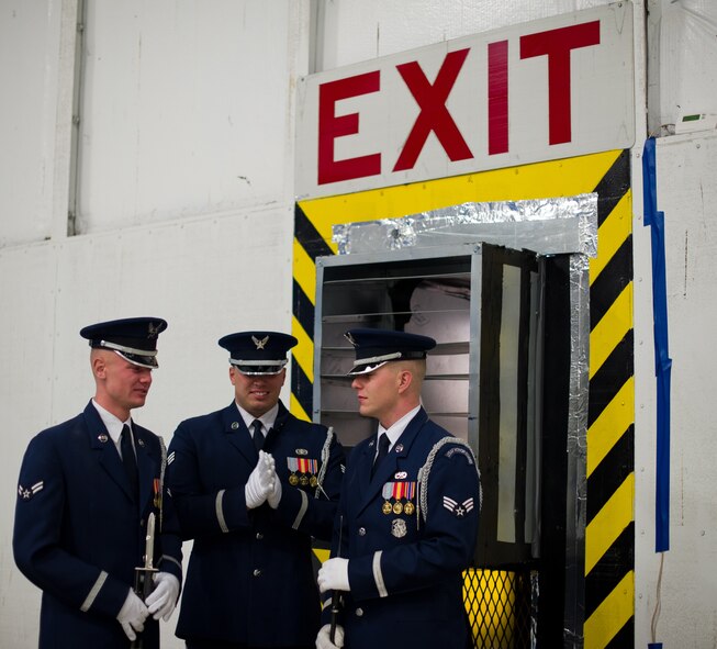 The U.S. Air Force Honor Guard members warm themselves in front of a heater before the Chief Master Sgt. of the Air Force Transition ceremony at Joint Base Andrews, Md., Jan. 24, 2013. Chief Master Sgt. James A. Cody became the 17th CMSAF following the retirement of Chief Master Sgt. James Roy. Roy's retirement will culminate more than 30 years of service. (U.S. Air Force photo/ Staff Sgt. Perry Aston)