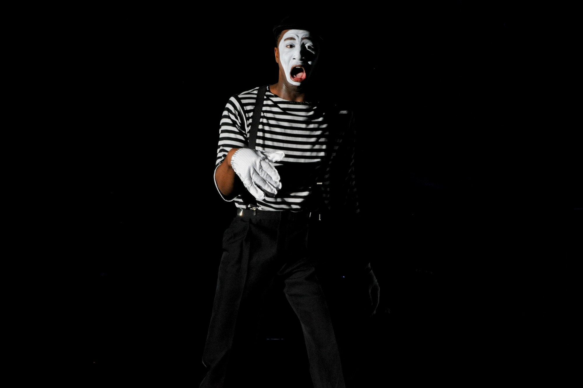 U.S. Air Force Airman 1st Class Jonathan Leak, Tops in Blue vocalist, mimes to the song “Grenade” by pop artist Bruno Mars at the Mathis Auditorium in Valdosta, Ga., Jan. 18, 2013. Tops in Blue covered a variety of popular musical artists ranging from Earth, Wind & Fire, to Maroon 5. (U.S. Air Force photo by Staff Sgt. Joshua J. Garcia/Released) 
