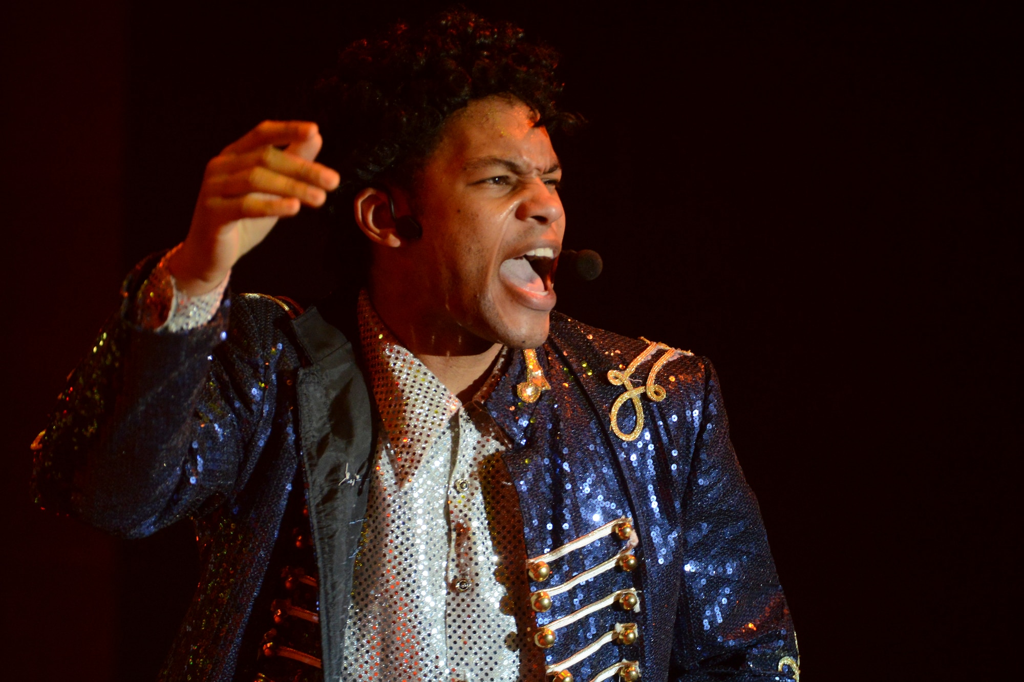 U.S. Air Force Staff Sgt. Tyron Jones, Tops in Blue vocalist, performs “Beat It” by Michael Jackson, at the Mathis Auditorium in Valdosta, Ga., Jan. 18, 2013. The band performed a montage of Jackson’s songs paying tribute to the late artist’s musical career. (U.S. Air Force photo by Staff Sgt. Joshua J. Garcia/Released) 