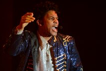 U.S. Air Force Staff Sgt. Tyron Jones, Tops in Blue vocalist, performs “Beat It” by Michael Jackson, at the Mathis Auditorium in Valdosta, Ga., Jan. 18, 2013. The band performed a montage of Jackson’s songs paying tribute to the late artist’s musical career. (U.S. Air Force photo by Staff Sgt. Joshua J. Garcia/Released) 