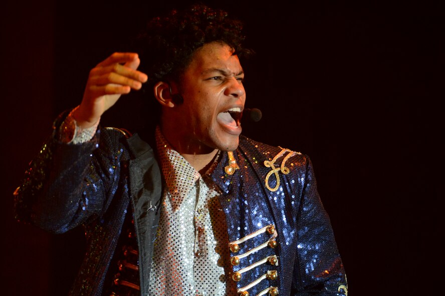 U.S. Air Force Staff Sgt. Tyron Jones, Tops in Blue vocalist, performs “Beat It” by Michael Jackson, at the Mathis Auditorium in Valdosta, Ga., Jan. 18, 2013. The band performed a montage of Jackson’s songs paying tribute to the late artist’s musical career. (U.S. Air Force photo by Staff Sgt. Joshua J. Garcia/Released) 