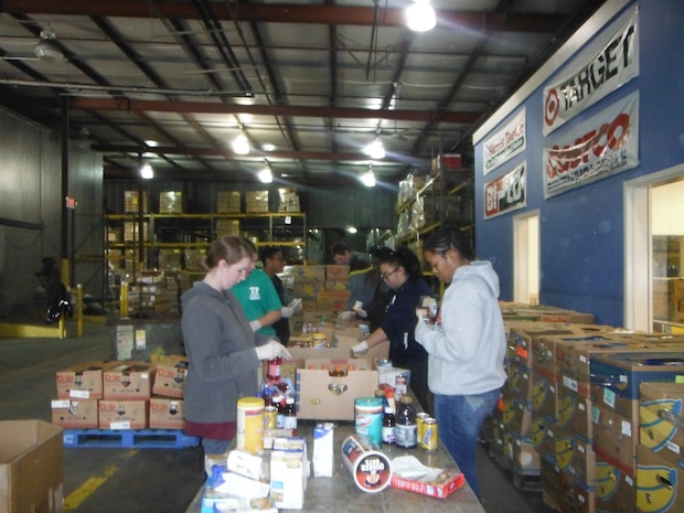 Volunteers from Joint Base Charleston – Air Base Teen Program participated in a Martin Luther King, Jr. day of service, Jan. 9, 2013, at the Lowcountry Food Bank in North Charleston, S.C. The teens sorted four tons of food items that were donated by major grocery stores. They checked for damaged and expired goods and items that can be reissued to special stores for low income families in need. (Courtesy photo)