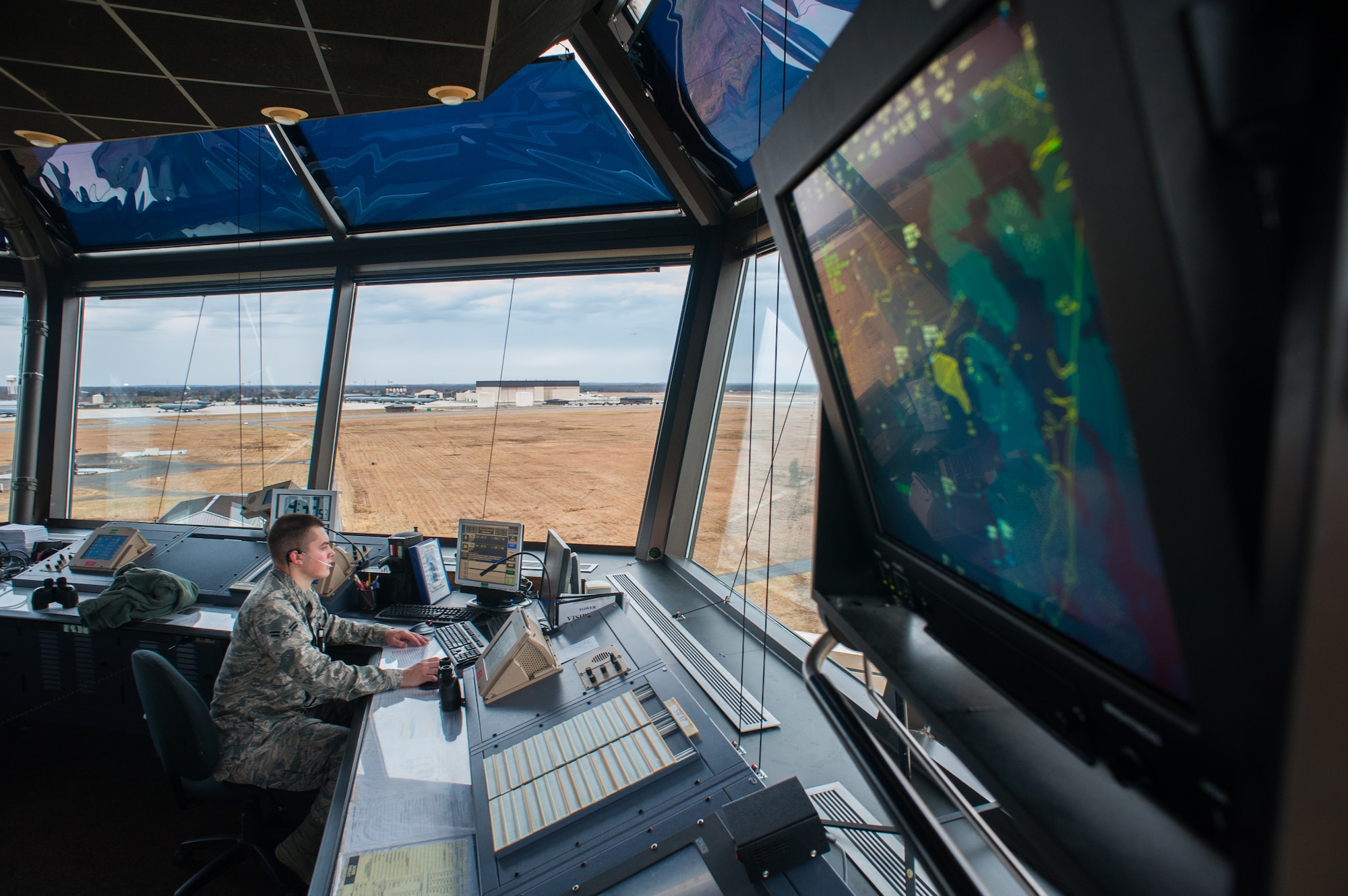 Airman 1st. Class Jonathan Drayer, 305th Operations Support Squadron air traffic controller, monitors the tower’s air space and runways for local control Jan. 11, 2013, at the air traffic control tower at Joint Base McGuire-Dix-Lakehurst, N.J. The OSS provides the safe flow of arrivals and departures 24/7 to JB MDL. Drayer hails from Beaver Falls, Pa. (U.S. Air Force photo by Russ Meseroll/Released)