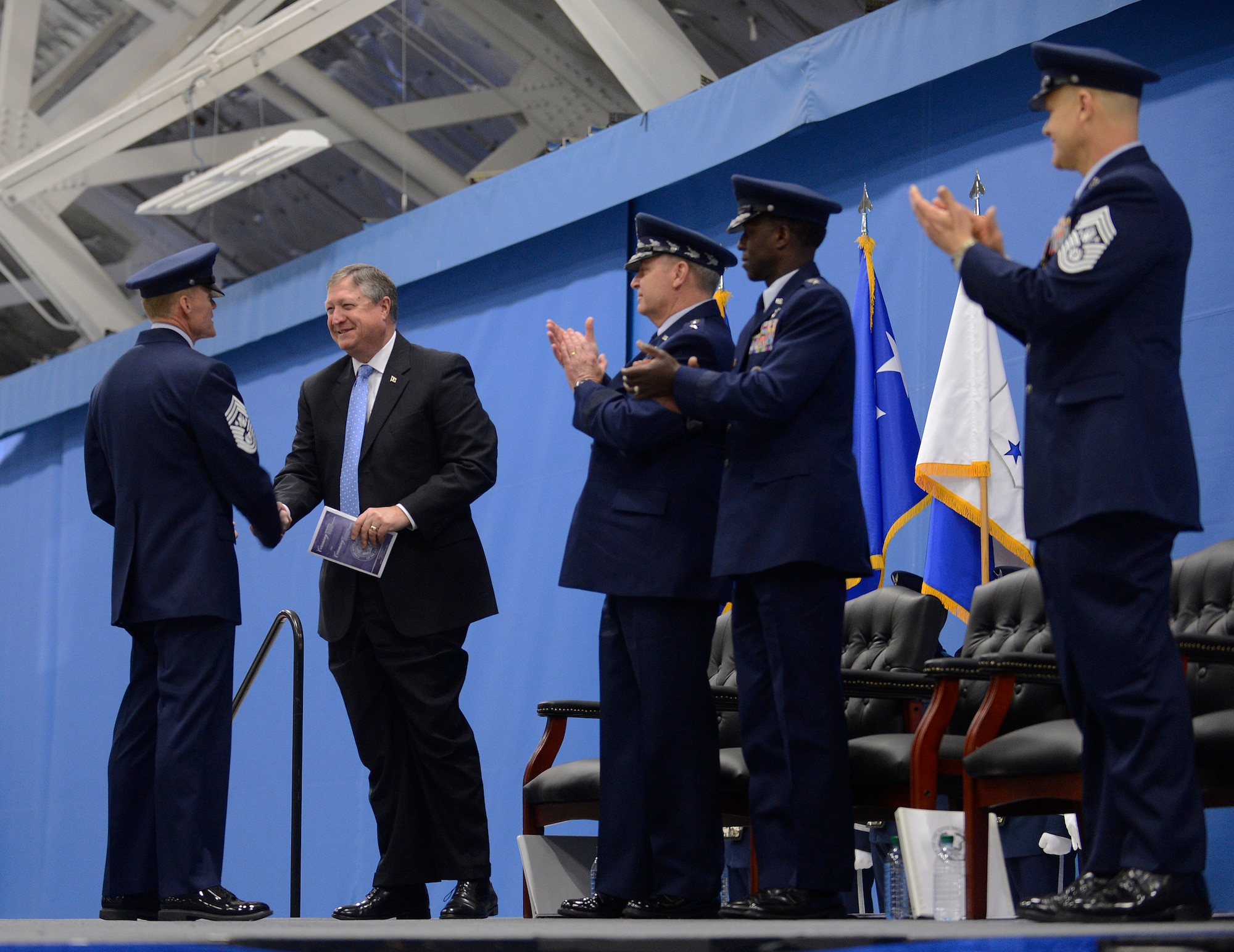 Secretary of the Air Force Michael Donley congratulates the newly appointed 17th Chief Master Sgt. of the Air Force James Cody during a retirement and transition ceremony on Joint Base Andrews, Md. on Jan. 24, 2013. Donley also bid farewell to Chief Master Sgt. of the Air Force James Roy who retired after more than 30 years of service. (U.S. Air Force photo/Jim Varhegyi)