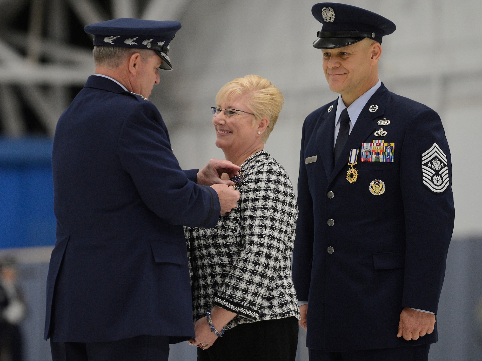Air Force Chief of Staff Gen. Mark A. Welsh III presents "Miss Paula" Roy, the wife of Chief Master Sgt. of the Air Force James Roy, with the Distinguished Public Service Medal during Chief Roy's retirement ceremony on Joint Base Andrews, Md. on Jan. 24, 2013. Roy, the 16th Chief Master Sgt. of the Air Force, is retiring after more than 30 years of service. (U.S. Air Force photo/Jim Varhegyi)