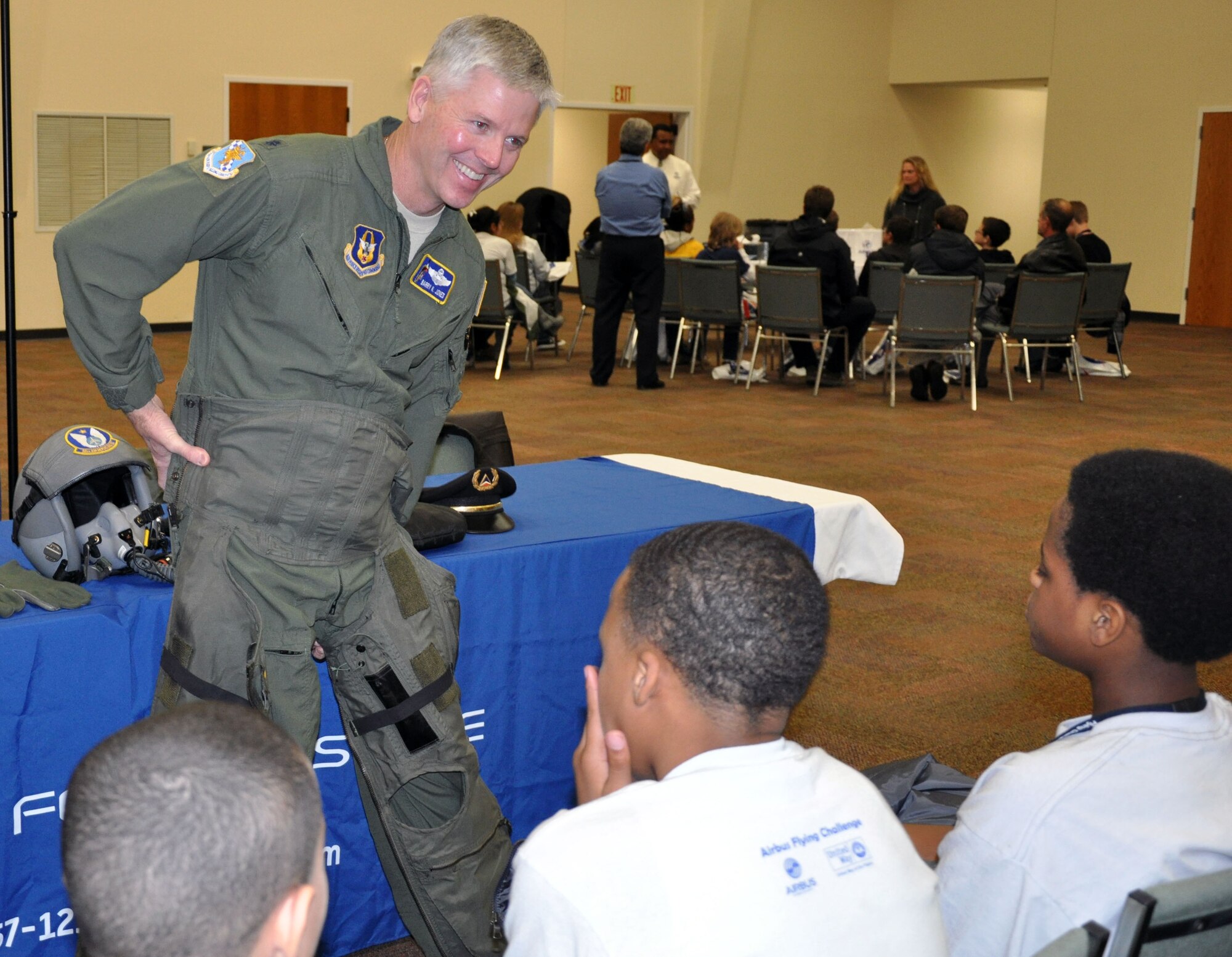 Lt. Col. Barry Jones, a KC-135 Stratotanker pilot assigned to the 931st Air Refueling Group, McConnell Air Force Base, Kan., shows students how a pilot wears an anti-gravity suit, or G-suit, to help withstand acceleration forces while maneuvering aircraft, Jan. 24, 2013.  Jones, who has also flown both the A-10 and B-1 aircraft, spoke to more than 80 junior high students about career opportunities in the Air Force Reserve during a career fair in Wichita.  Recruiters as well as members of the 931st from various career fields visited with the students as well.  (U.S. Air Force photo by 1st Lt. Zach Anderson)