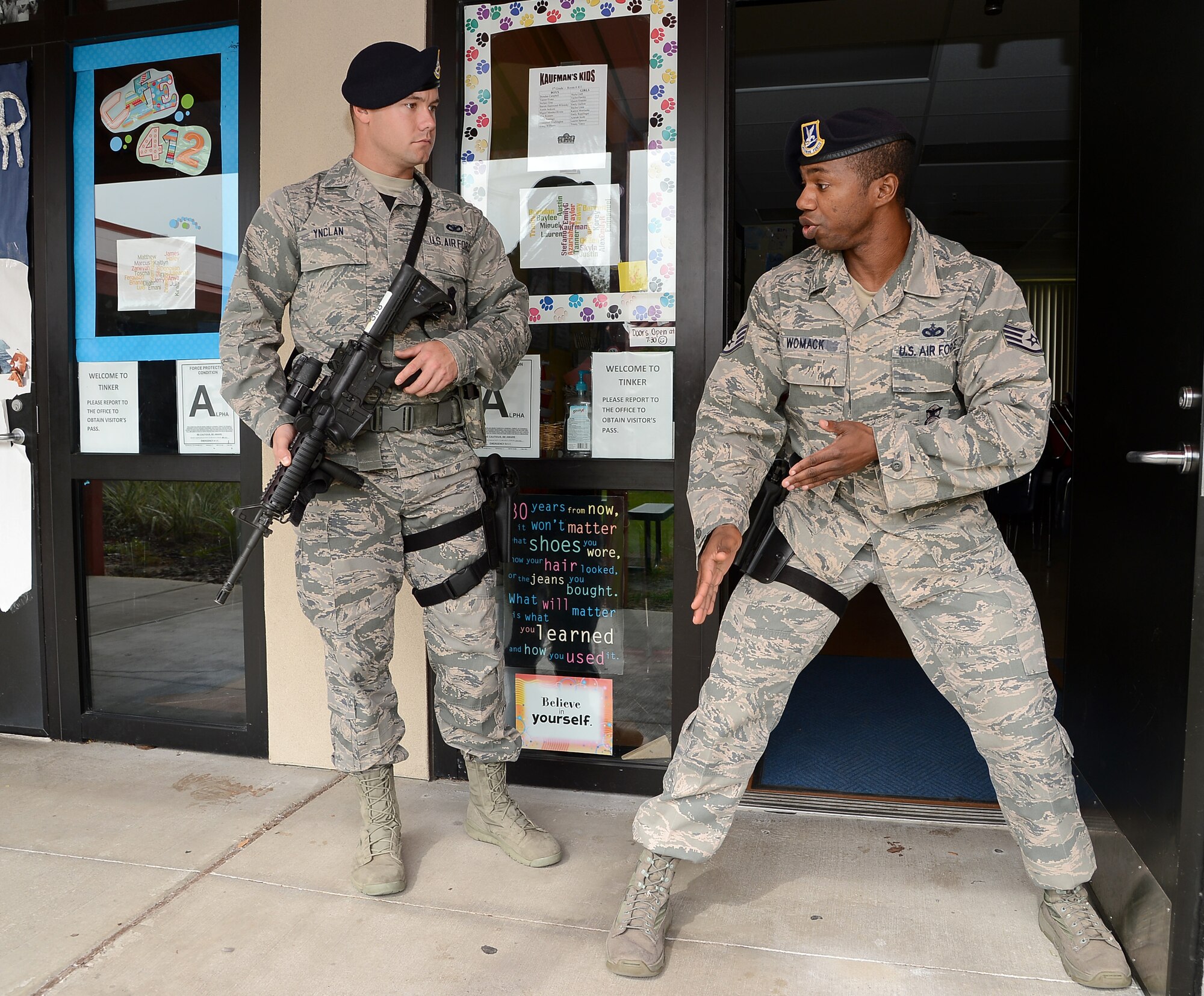 Staff Sgt. Mike Womack, 6th Security Force Squadron raven, demontrates the proper way to guard a doorway to Airman 1st Class Shane Ynclan, 6th SFS patrolman, during an active shooter exercise at Tinker Elementary School,  MacDill Air Force Base, Fla., Jan 22, 2013. The exercise gave Security Forces Airmen as well as representatives from the Hillsborough County School District and the Tampa Police Department the opportunity to become familiar with the school’s security procedures. (U.S. Air Force photo by Airman 1st Class David Tracy/Released)