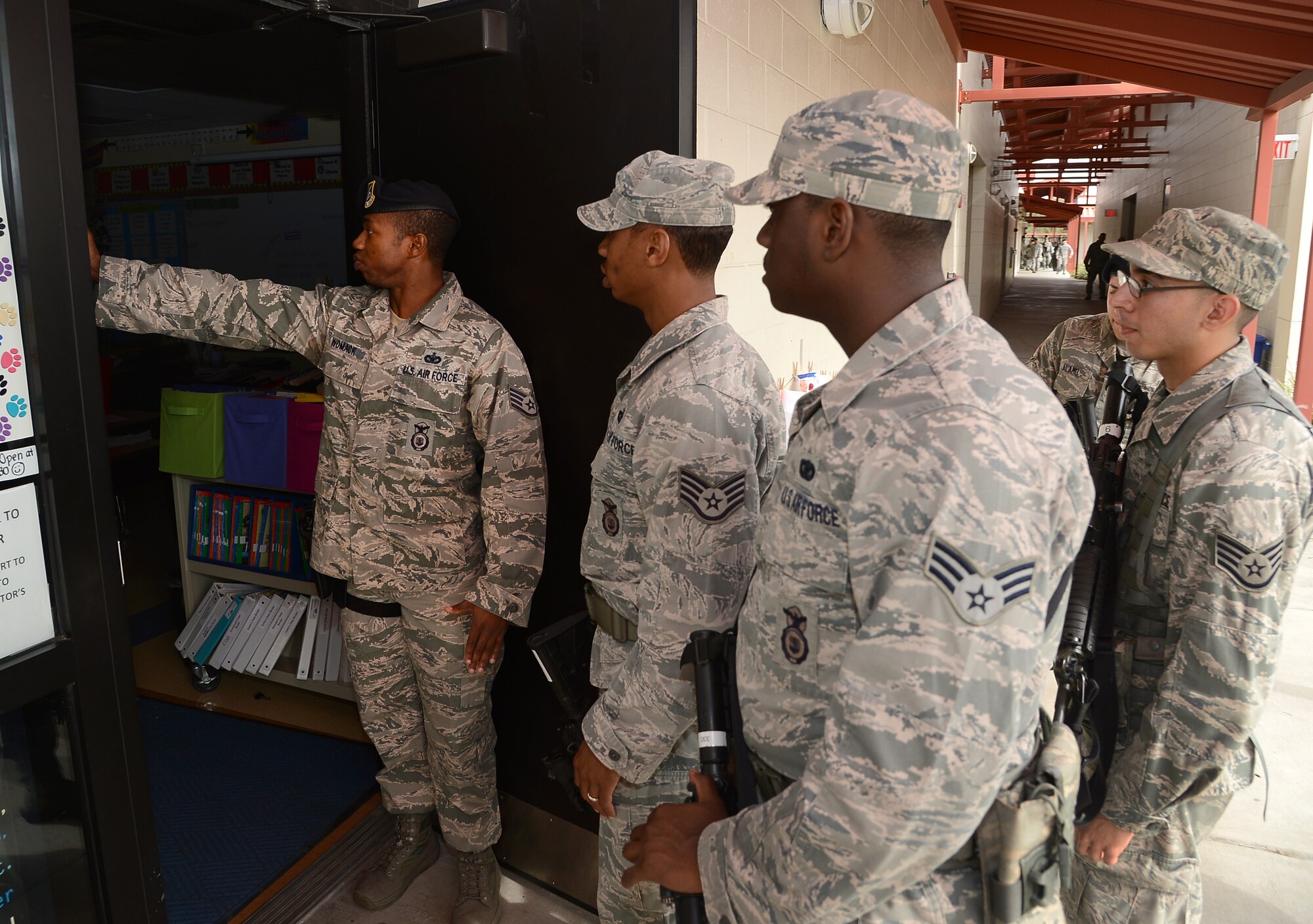 Staff Sgt. Mike Womack, 6th Security Forces Squadron raven, instructor 6th SFS Airmen on proper techniques for clearing a room during an active shooter exercise at Tinker Elementary School, MacDill Air Force Base, Fla., Jan 22, 2013. Representatives from Hillsborough County School District and the Tampa Police Department also attended the school walk through. (U.S. Air Force photo by Airman 1st Class David TracyStaff Sgt. Willie Hayes, 6th Security Forces Squadron patrolman, leads a team of security forces members in proper clearing procedures during an active shooter exercise at Tinker Elementary School during on MacDill Air Force Base, Fla., Jan. 22, 2013. Representatives from Hillsborough County School District and the Tampa Police Department also attended the school walk through. (U.S. Air Force photo by Airman 1st Class David Tracy/Released)