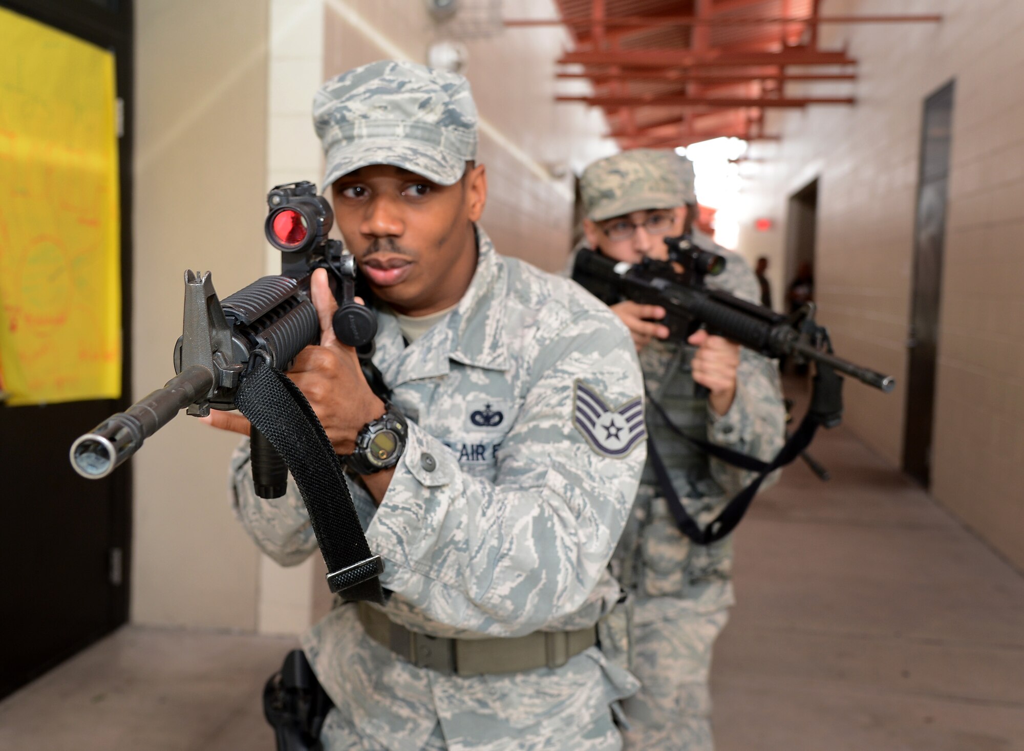Staff Sgt. Willie Hayes, 6th Security Forces Squadron patrolman, leads a team of security forces members in proper clearing procedures during an active shooter exercise at Tinker Elementary School during on MacDill Air Force Base, Fla., Jan. 22, 2013. Representatives from Hillsborough County School District and the Tampa Police Department also attended the school walk through. (U.S. Air Force photo by Airman 1st Class David Tracy/Released)