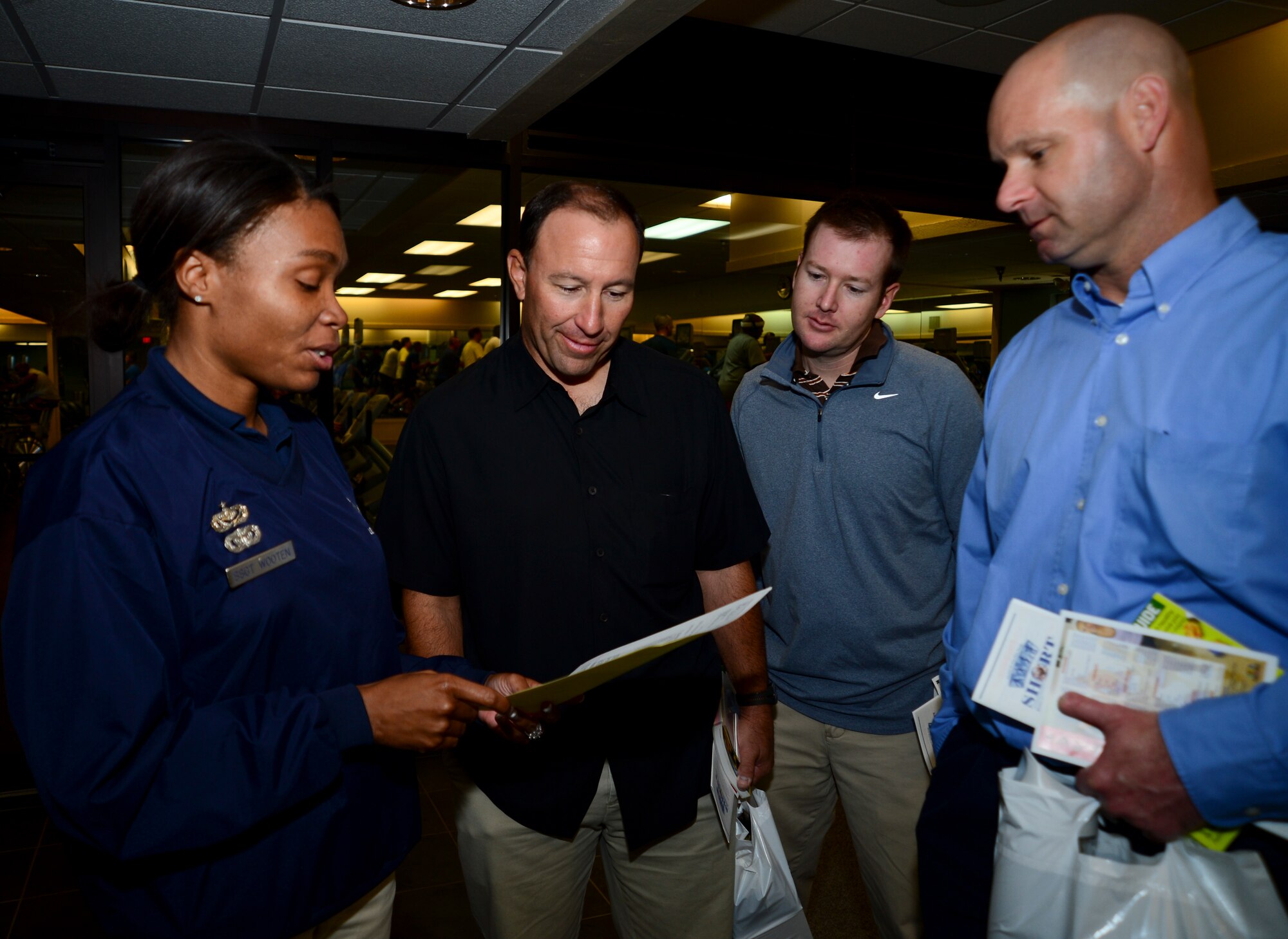 Staff Sgt. Lashonna Wooten, 6th Force Support Squadron fitness assessment cell NCO in charge, shows members of the Tampa Bay Ray’s training staff the Air Force fitness assessment work sheet at MacDill Air Force Base, Fla., Jan. 22, 2013. The trainers spoke about how impressed they were with the Air Force standards. (U.S. Air Force photo by Senior Airman Melissa Paradise)    