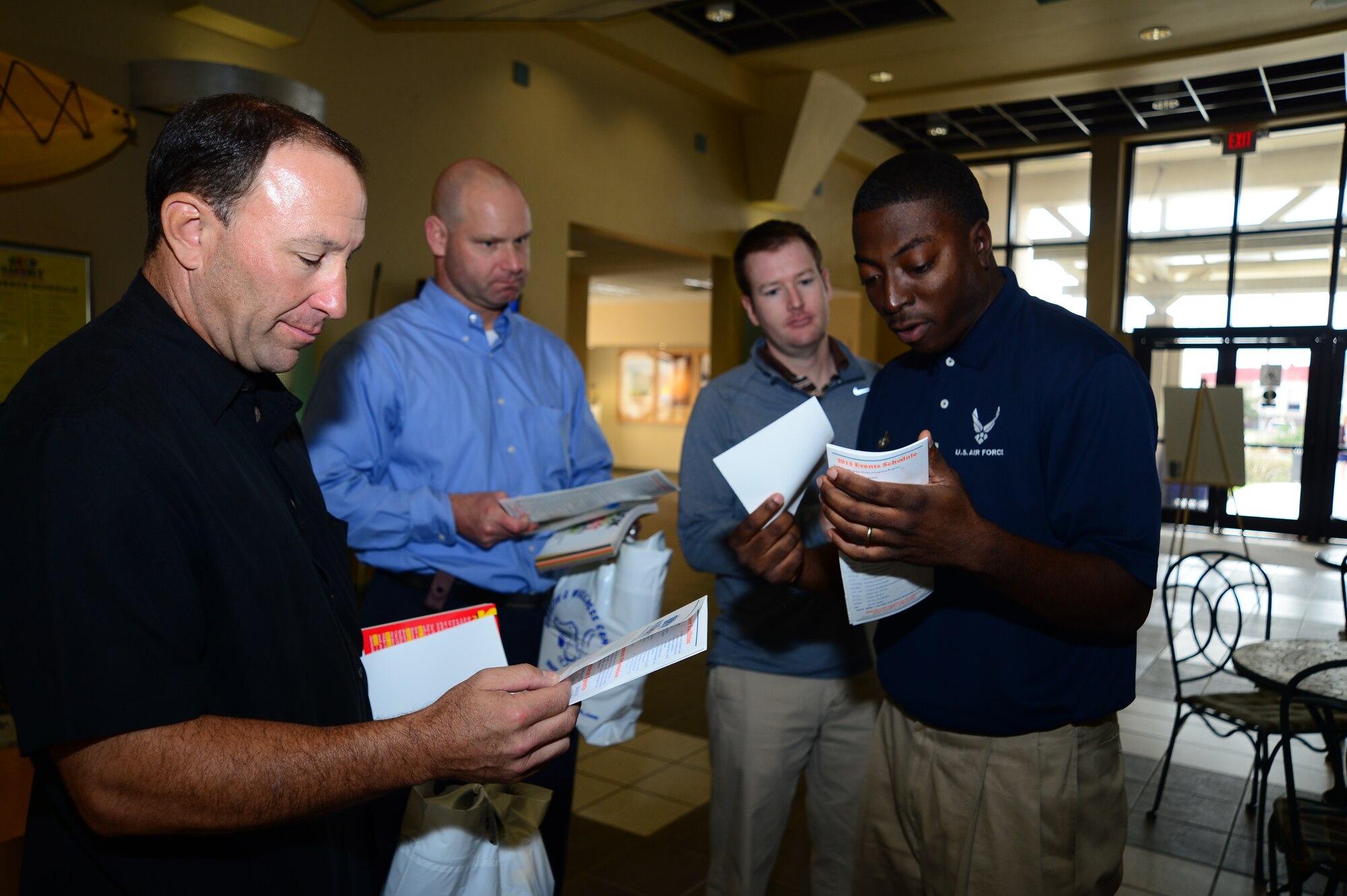 Staff Sgt. Henry Bennett, 6th Force Support Squadron fitness specialist, shows the members of the Tampa Bay Rays training staff a list of classes and workout programs that the fitness center offers at MacDill Air Force Base, Fla., Jan. 22, 2013. The trainers and fitness staff had a chance to discuss types of workouts and talk about how to avoid injuries. (U.S. Air Force photo by Senior Airman Melissa Paradise/Released)   