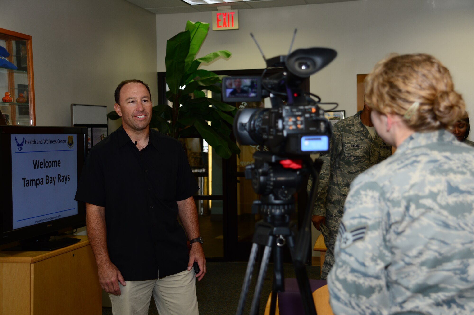 Senior Airman Laura Beckley, 6th Air Mobility Wing broadcaster, conducts an interview with Ron Porterfield, Tampa Bay Rays head trainer, during his visit to MacDill Air Force Base, Fla., Jan. 22, 2013. Porterfield, along with two assistant trainers, toured the Medical Group facilities and the fitness centers. (U.S. Air Force photo by Senior Airman Melissa Paradise/Released)   