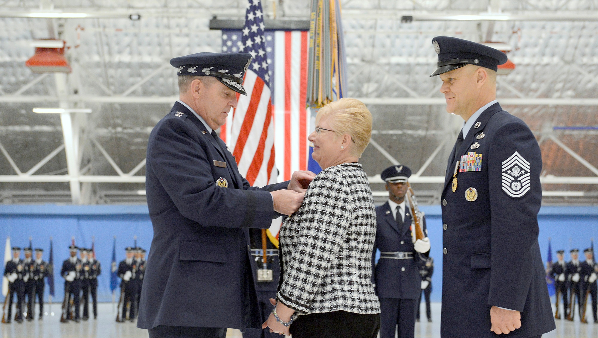 Air Force Chief of Staff Gen. Mark A. Welsh III presents Paula Roy, wife of  Chief Master Sgt. of the Air Force James Roy, the Distinguished Public Service award at Joint Base Andrews, Md., on Jan. 24, 2013, during Roy's retirement ceremony. (U.S. Air Force photo/Scott M. Ash)