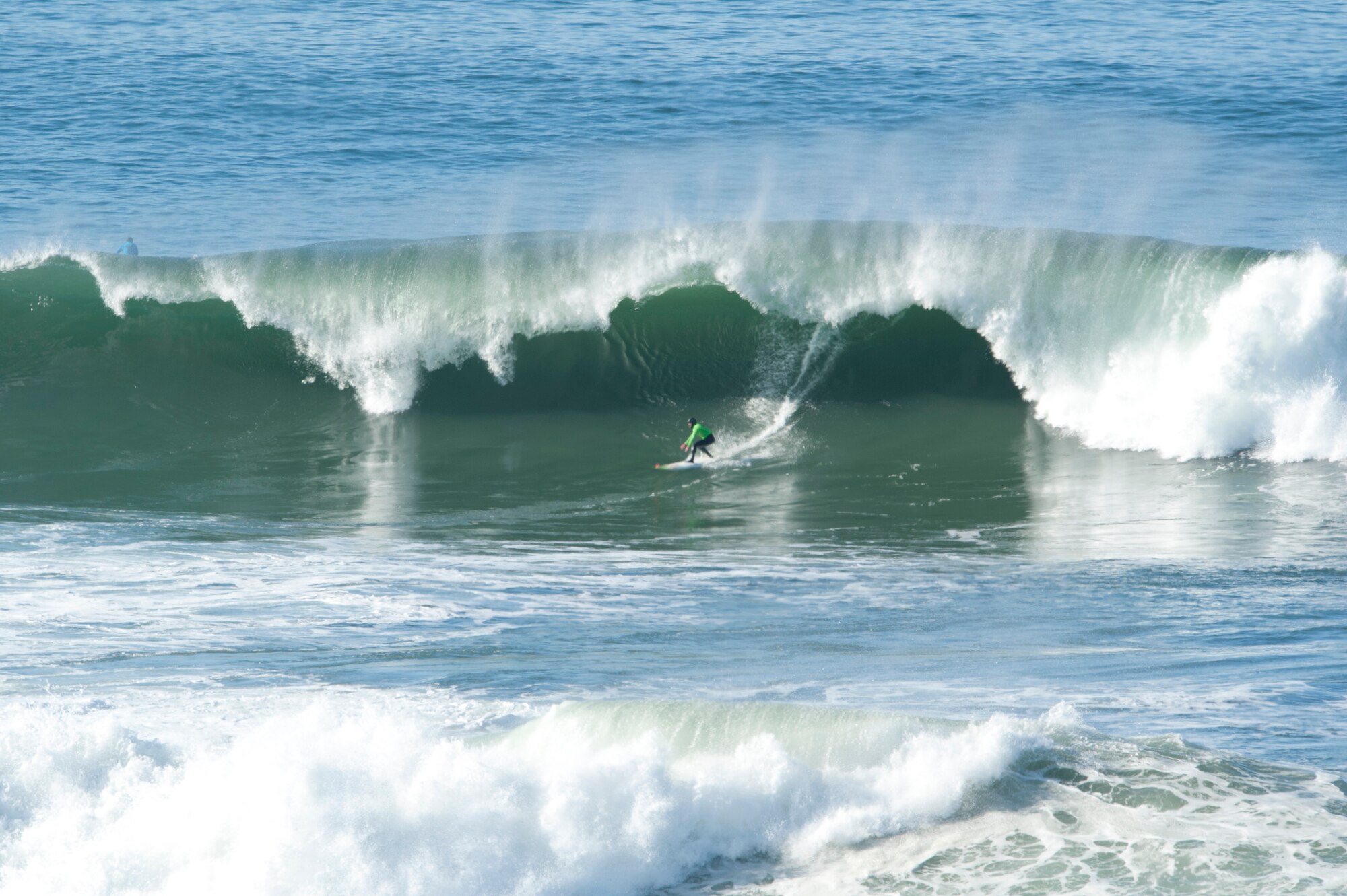 HALF MOON BAY, Calif. – Zach Wormhoudt, Santa Cruz surfer, speeds underneath a wave crest during the 2013 Mavericks Invitational just north of Half Moon Bay here Sunday, Jan. 20, 2013. Mavericks are waves that can crest up to 50 feet with tremendously strong currents, dangerous rocks and shallow reefs coupled with frigid water temperatures, which attract attention from surfers world-wide.  (U.S. Air Force photo/Senior Airman Lael Huss)