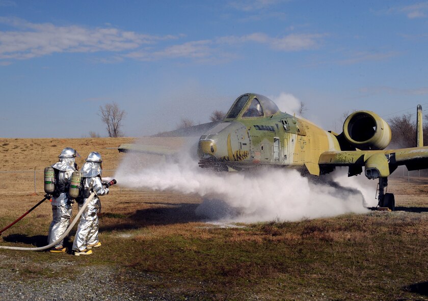 Airmen 1st Class Xazier Bailey and Juan Rosario, 2nd Civil Engineer Squadron firefighters, spray an A-10 Thunderbolt II with a dry chemical agent and water on Barksdale Air Force Base, La., Jan. 23. A dry chemical agent is used on metal fires. Water is used to contain the dry chemical agent dust because it is a respiratory irritant. (U.S. Air Force photo/Airman 1st Class Benjamin Gonsier)
