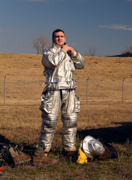Airman 1st Class Xazier Bailey, 2nd Civil Engineer Squadron firefighter, dons his fire proximity suit on Barksdale Air Force Base, La., Jan. 23. The fire proximity suit is used specifically for aircraft fires and protects the firefighter from thermal radiation. Firefighters who deal with aircraft fires wear fire proximity suits to protect themselves from temperatures that can reach up to 2,000 degrees Fahrenheit. (U.S. Air Force photo/Airman 1st Class Benjamin Gonsier)