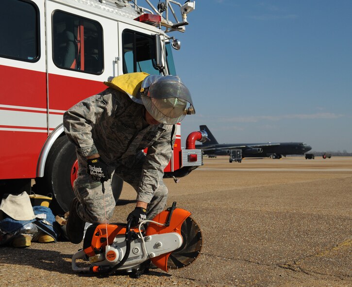 Airman 1st Class Xazier Bailey, 2nd Civil Engineer Squadron firefighter, inspects a K-12 fire rescue saw on Barksdale Air Force Base, La., Jan. 23. In the event of a fire emergency, firefighters use the saw to cut through material to get to those in immediate danger. (U.S. Air Force photo/Airman 1st Class Benjamin Gonsier)
