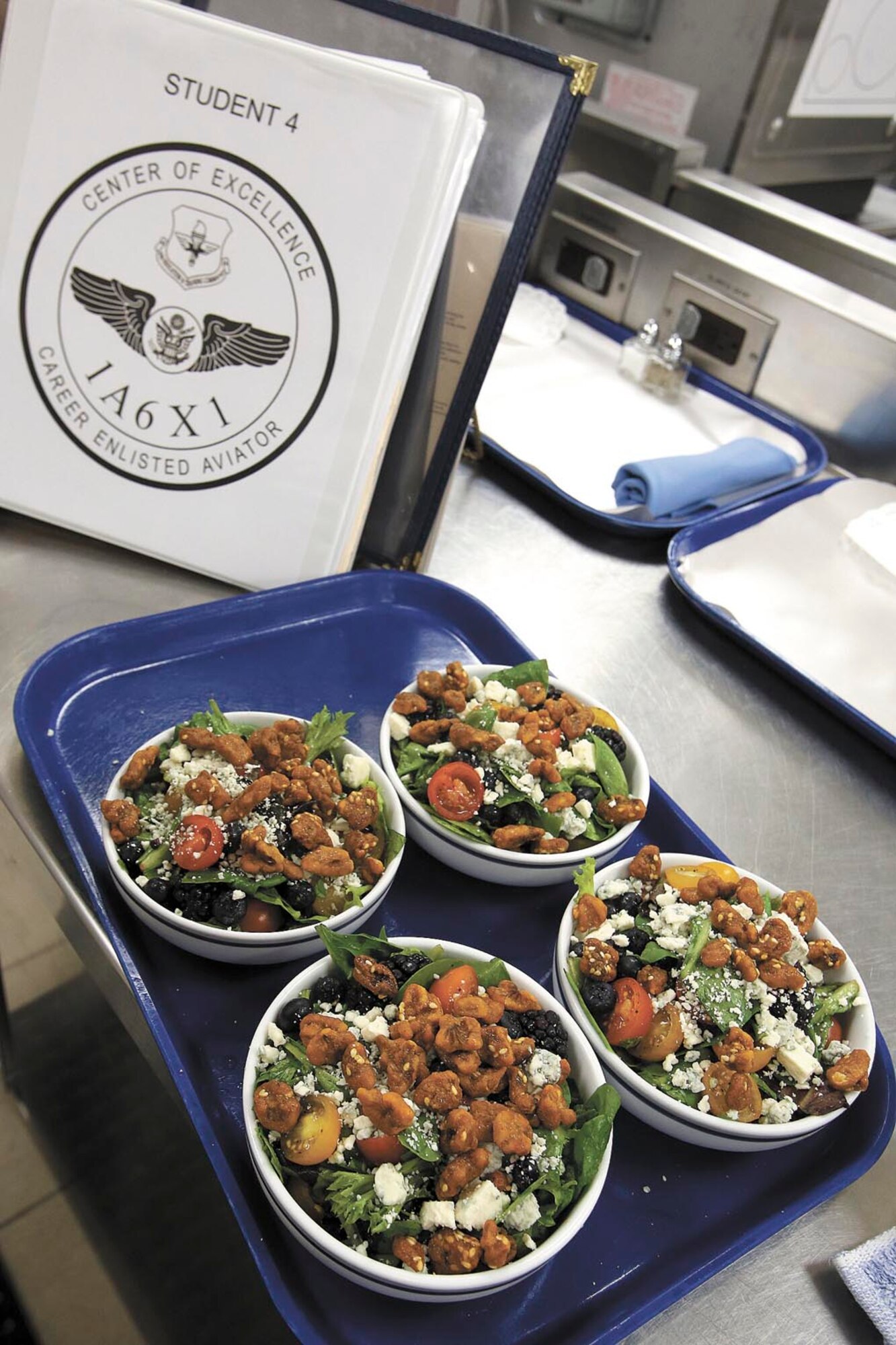 Staff Sgt. Nichole Griffith's student handbook sits next to her specially-prepared muslin feta walnut salad ready to be served as a preliminary to the main course. (Photo by Robbin Cresswell)