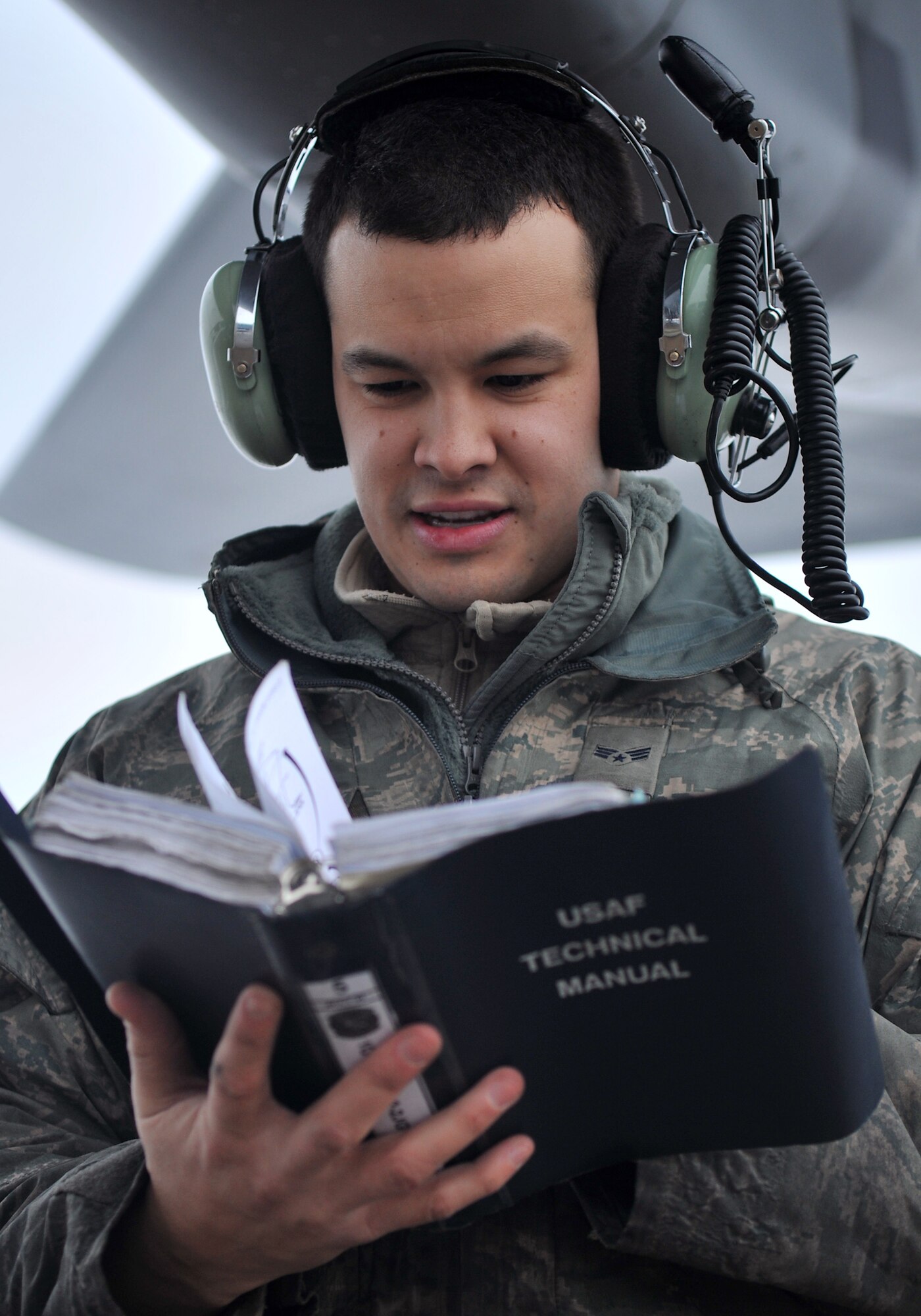Senior Airman Spencer Lujan, 100th Aircraft Maintenance Squadron crew chief from St. Peters, Mo., reads a technical order before a task on the flightline Jan. 23, 2013, at RAF Mildenhall, England. Maintenance personnel refer to technical orders before every task performed to ensure all steps are completed correctly. (U.S. Air Force photo by Senior Airman Jerilyn Quintanilla/Released)