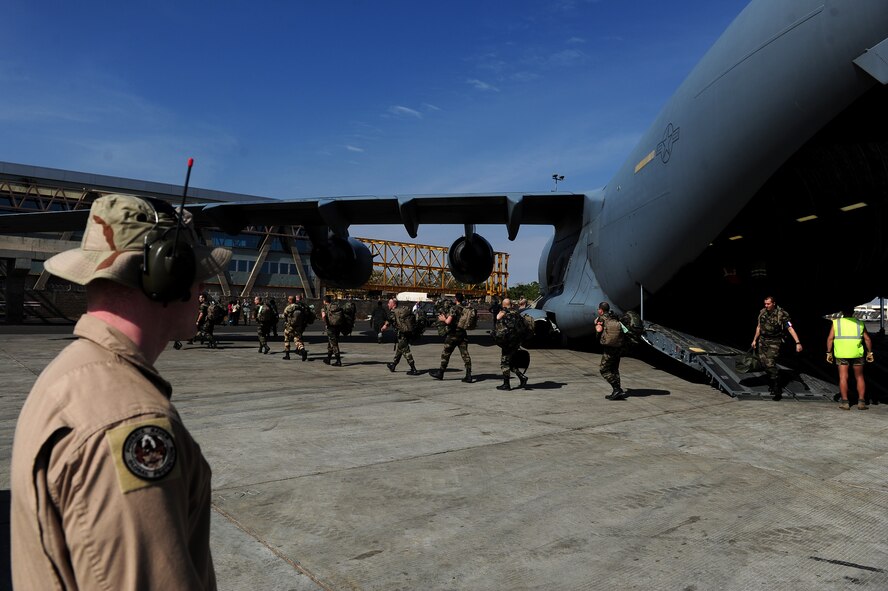 French soldiers exit a U.S. Air Force C-17 Globemaster III after arriving in Mali Jan. 20, 2013, as France increases its presence in the country to fight off extremists that have taken control of much of the Northern part of the country, Jan. 20, 2013. The United States has agreed to support France by airlifting troops and equipment into Mali. (U.S. Air Force photo/Senior Airman James Richardson)