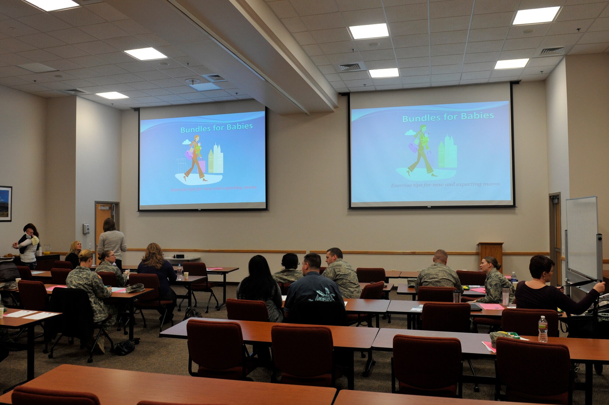 Team Buckley members attend the Bundles for Babies seminar Jan. 23, 2013, at Buckley Air Force Base, Colo. The seminar, which is held every other month, includes a finance class that focuses on budgeting for a new family member and the support programs the military community offers for parents-to-be. Other presentations at the class include fitness before and after pregnancy, new parenthood and new-parent support, and brain games for boosting a baby’s mental development. (U.S. Air Force photo by Airman 1st Class Riley Johnson/Released)