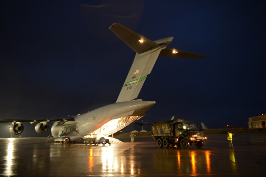 U.S. Airmen load French military vehicles into an. Air Force C-17 Globemaster III cargo aircraft in Istres, France, Jan. 23, 2013. The Air Force aircraft are transporting French troops and equipment to Mali in support of French operations in the country. (U.S. Air Force photo/Staff Sgt. Nathanael Callon)