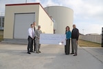 Yvonne Haecker, CPS Energy Solutions manager, present a check for $154,996.71 to Col. Christine Erlewine, 902nd Mission Support Group commander, Jan 23. at Joint Base San Antonio-Randolph. From left to right, Ruben Ramos, Joint Base San Antonio-Randolph energy manager, Bruce Dschuden, JBSA-Randolph efficiency manager, Erlewine, Haecker and Juan Novan, senior mechanical engineer project manager. (U.S. Air Force photo by Joshua Rodriguez)