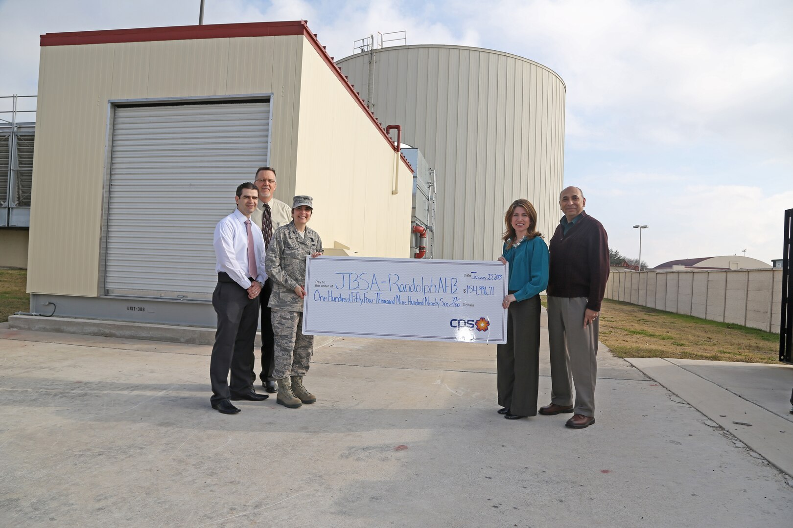 Yvonne Haecker, CPS Energy Solutions manager, present a check for $154,996.71 to Col. Christine Erlewine, 902nd Mission Support Group commander, Jan 23. at Joint Base San Antonio-Randolph. From left to right, Ruben Ramos, Joint Base San Antonio-Randolph energy manager, Bruce Dschuden, JBSA-Randolph efficiency manager, Erlewine, Haecker and Juan Novan, senior mechanical engineer project manager. (U.S. Air Force photo by Joshua Rodriguez)