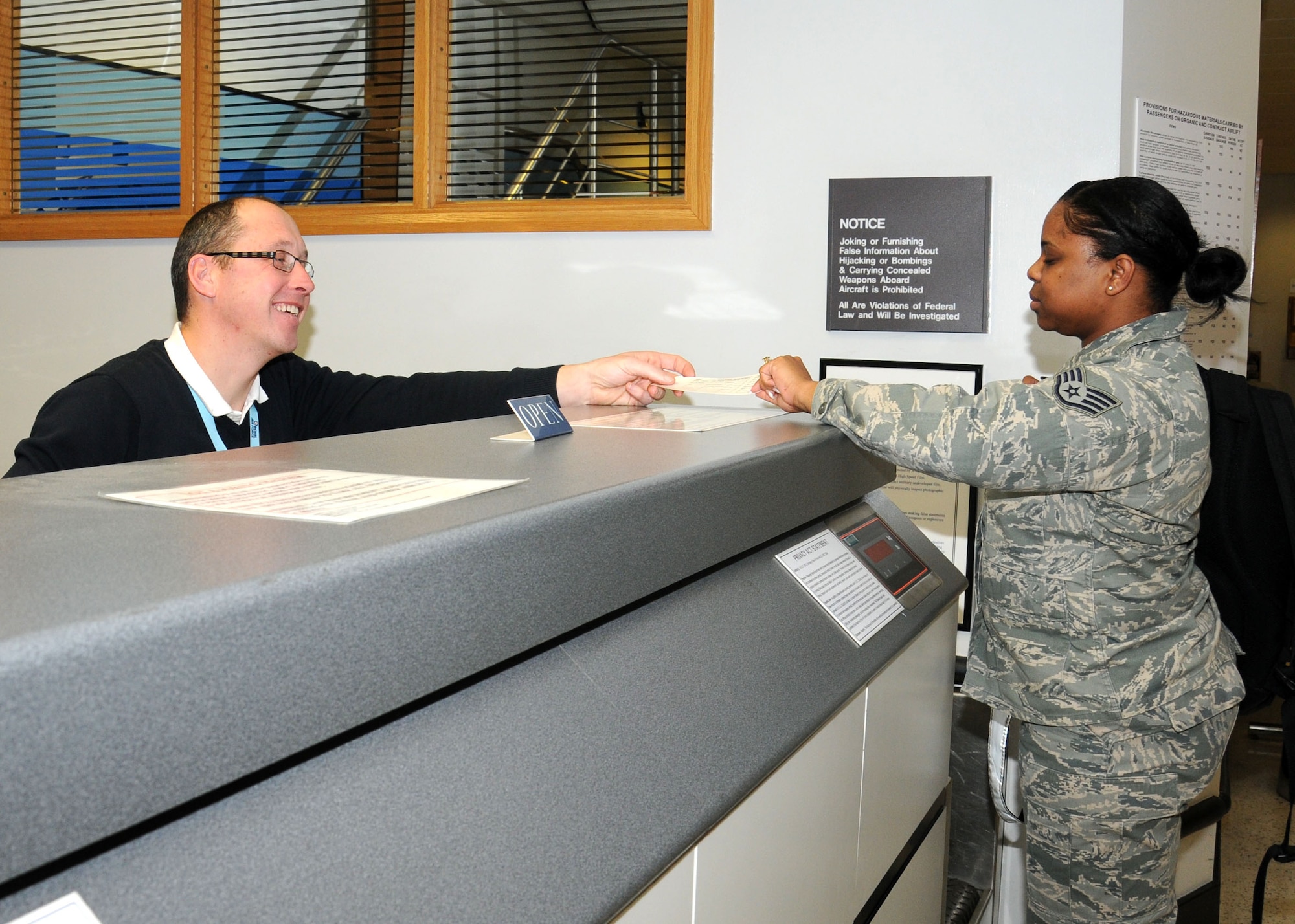 Jonathan Coomber, 727th Air Mobility Squadron passenger service agent, checks in a passenger Jan. 23, 2013, at the RAF Mildenhall Passenger Terminal, England. The terminal is open from 6 a.m. to 10 p.m. Monday to Sunday offering military members and their dependents, as well as retirees, space available travel. For more information visit http://www.mildenhall.af.mil/units/rafmildenhallpassengerterminal.asp
 (U.S. Air Force photo by Gina Randall/Released)
