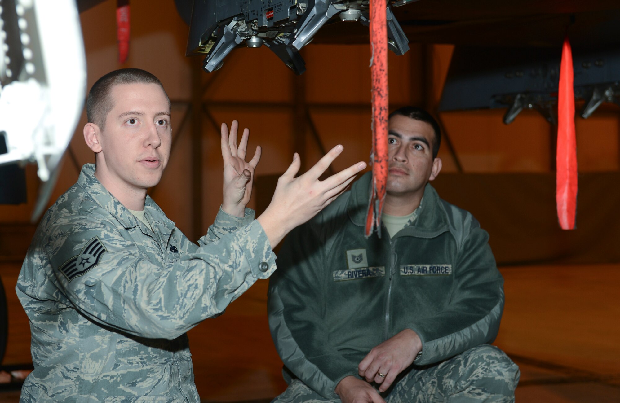 ROYAL AIR FORCE LAKENHEATH, England - Staff Sgt. Derek Dardis, 48th Maintenance Operation Squadron weapon standardization load crew member and native of Suffolk, Va., talks to Maintainer for a Day participants about bomb racks on an F-15E Strike Eagle Jan. 18, 2013. The Maintainer for a Day program allowed Airmen who work in units other than the 48th Maintenance Group to experience what it is like to be an aircraft maintainer. (U.S. Air Force photo by Staff Sgt. Stephen Linch)