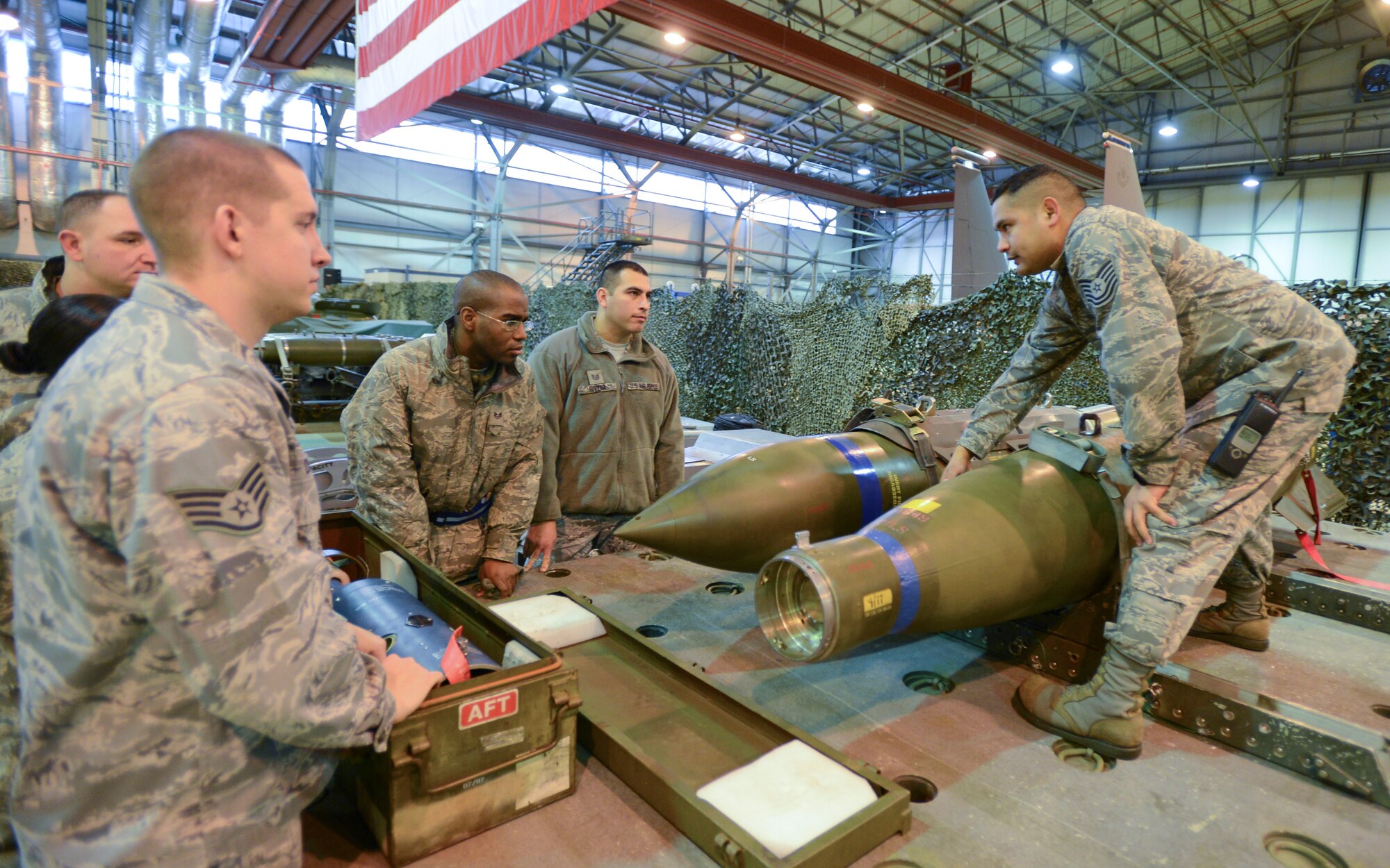 ROYAL AIR FORCE LAKENHEATH, England - Tech. Sgt. Ruben TrejoSanchez, 493rd Aircraft Maintenance Unit NCO in charge of maintenance and native of Rapid City, S.D., shows Maintainer for a Day participants a Guided Bomb Unit -31 and a GBU-10, both inert 2,000 pound units used for training, Jan. 18, 2013. Throughout the event, participants were given insight into F-15C Eagle, F-15E Strike Eagle and HH-60G Pave Hawk maintenance. (U.S. Air Force photo by Staff Sgt. Stephen Linch)