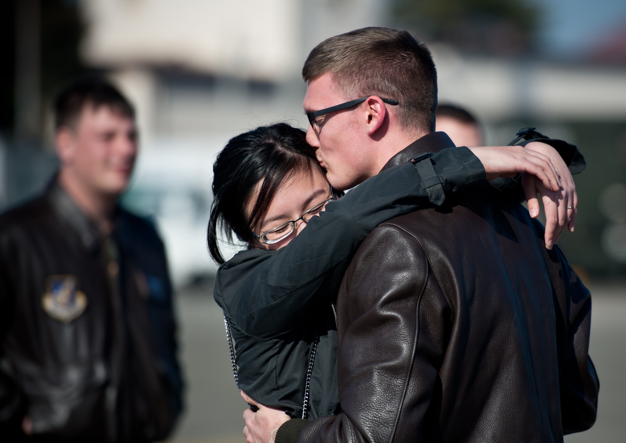 Capt. Jacob Morton embraces his wife, Carmen, for the first time in four months at Yokota Air Base, Japan, Jan. 24, 2013. Morton is a C-130 Hercules navigator for the 36th Airlift Squadron. (U.S. Air Force photo by Senior Airman Cody H. Ramirez)