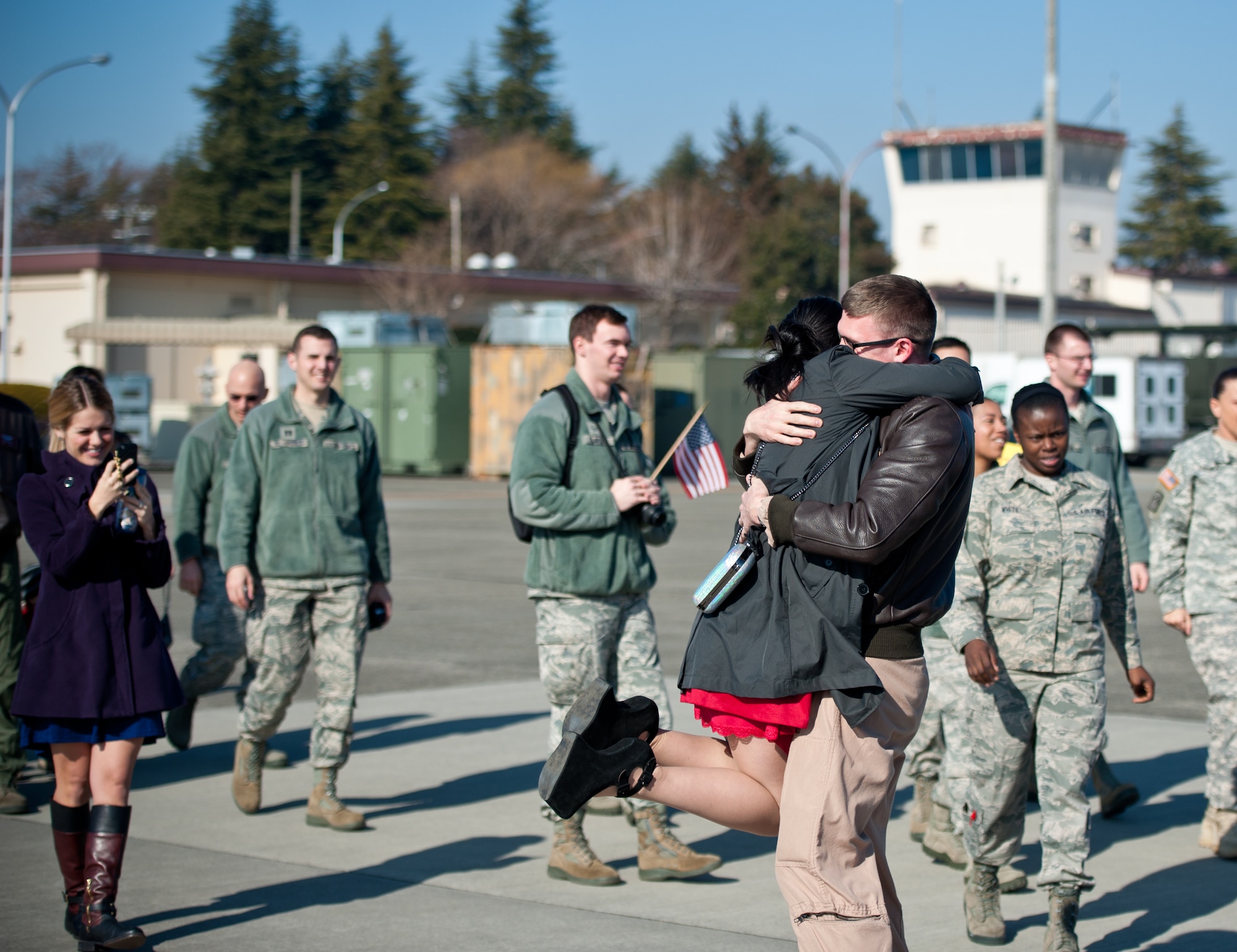 Capt. Jacob Morton, 36th Airlift Squadron C-130 Hercules navigator, hugs his wife, Carmen, during a welcome-home event at Yokota Air Base, Japan, Jan. 24, 2013. The navigator, along with 27 Yokota members, deployed for four months to Southwest Asia. While deployed the crew conducted resupplies, hauled equipment, transported combat-ready troops and flew medical evacuation missions. (U.S. Air Force photo by Senior Airman Cody H. Ramirez)