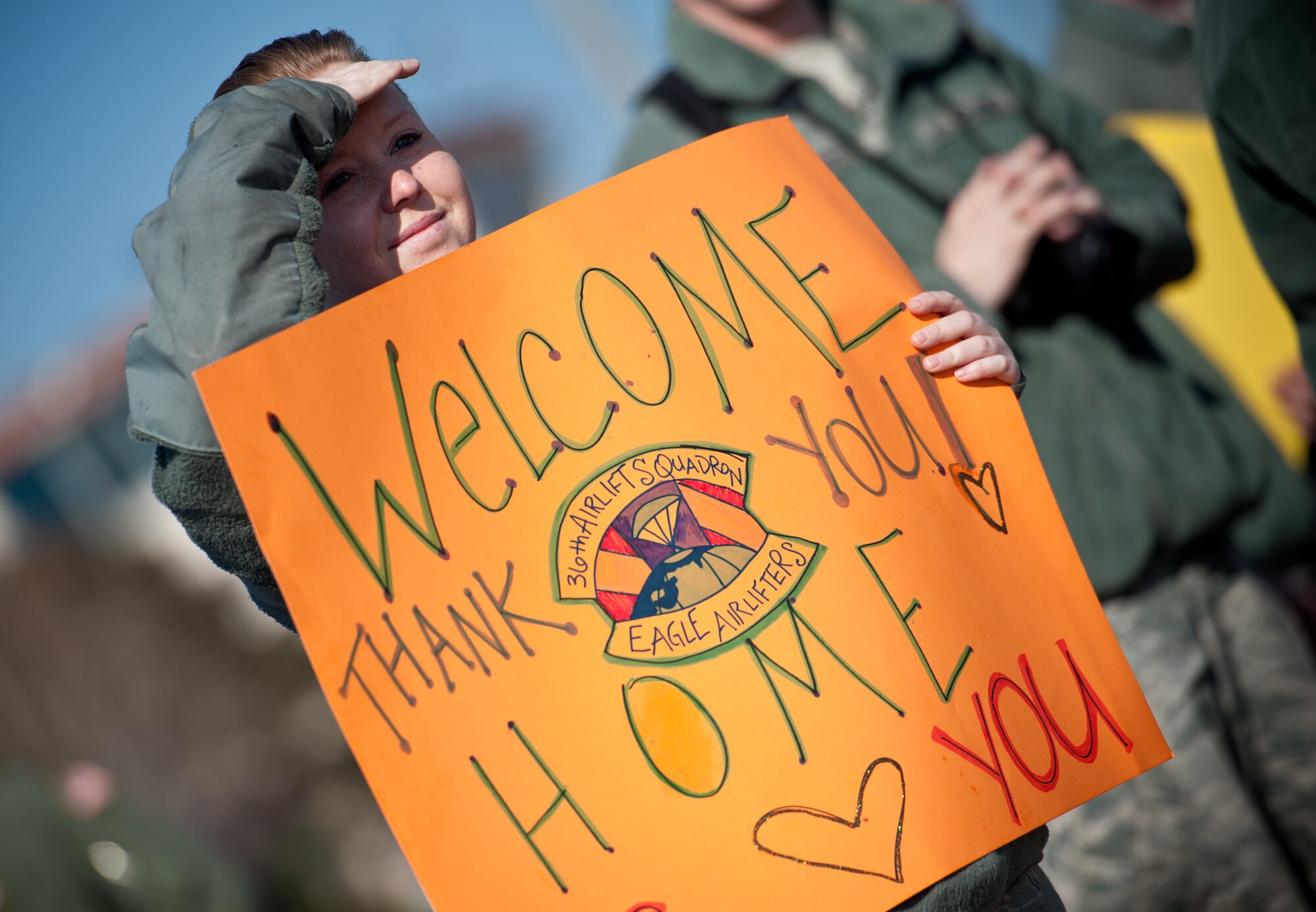 A Yokota member shows her support for members of 36th Airlift Squadron returning from a four-month deployment at Yokota Air Base, Japan, Jan. 24, 2013. Yokota sent 27 aircrew members to Southwest Asia to transport combat ready troops and supply throughout their designated theater. (U.S. Air Force photo by Senior Airman Cody H. Ramirez)