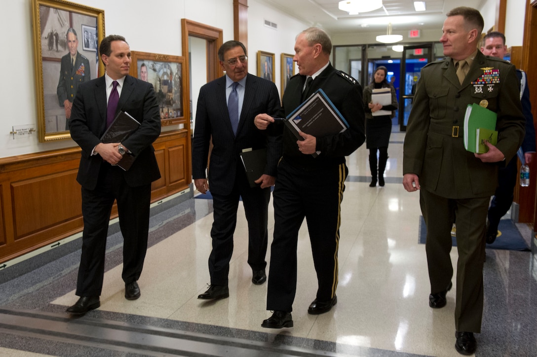Defense Secretary Leon E. Panetta, center left, and Army Gen. Martin E. Dempsey, chairman of the Joint Chiefs of Staff, center right, walk through the Pentagon after briefing the press with aides Jeremy Bash, left, chief of staff, and Marine Corps Col. David Lapan at the Pentagon, Jan. 24, 2013.