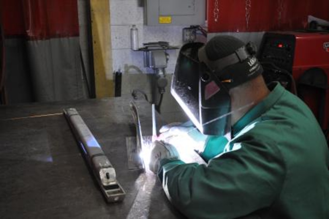 Alcario Castaneda, a welder at Marine Depot Maintenance Command, welds a component, Jan. 11. Workers with MDMC weld metals for multiple vehicles such as LAVs, MRAPs and MATVs.