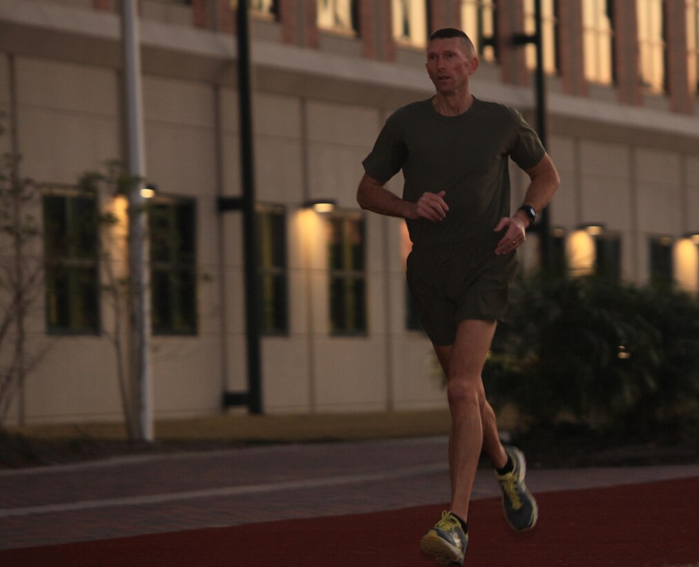 Lt. Col. Dean Keck, a maintenance officer for Marine Forces Reserve, runs around the track at the Marine Corps Support Facility New Orleans in the early morning of Jan. 23, 2013.  Keck has scored a perfect 300 on every physical fitness test since he enlisted in 1984, amassing 54 total 300 PFTs.  He has run perfect PFTs all over the world – in Japan, in Iraq, and in Afghanistan.  