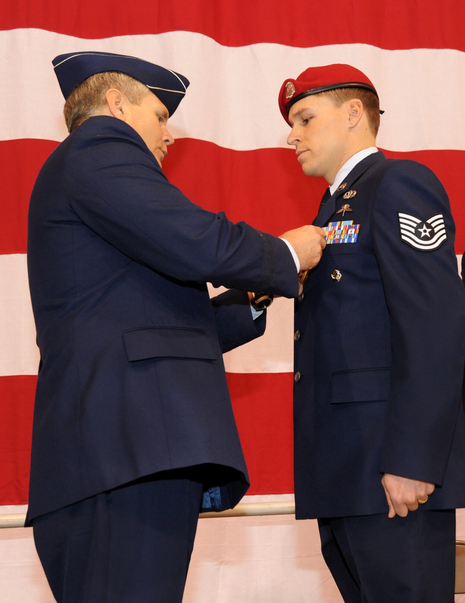 U.S. Air Force Lt. Gen. Eric E. Feil, commander of Air Force Special Operations Command, awards the Purple Heart Medal to Tech. Sgt. Douglas J. Matthews of the 125th Special Tactics Squadron during an award ceremony held at the Portland Air National Guard Base, Portland, Ore., Jan. 23.  The event honored Airmen from the unit with five Bronze Star Medals and one Purple Heart medal.  The Airmen earned the medals during recent deployments to the Middle East. Fiel flew in from AFSOC headquarters at Hulburt Field, Fla., for the ceremony (U.S. Air Force photo by Tech. Sgt. John Hughel, 142nd Fighter Wing Public Affairs/Released)