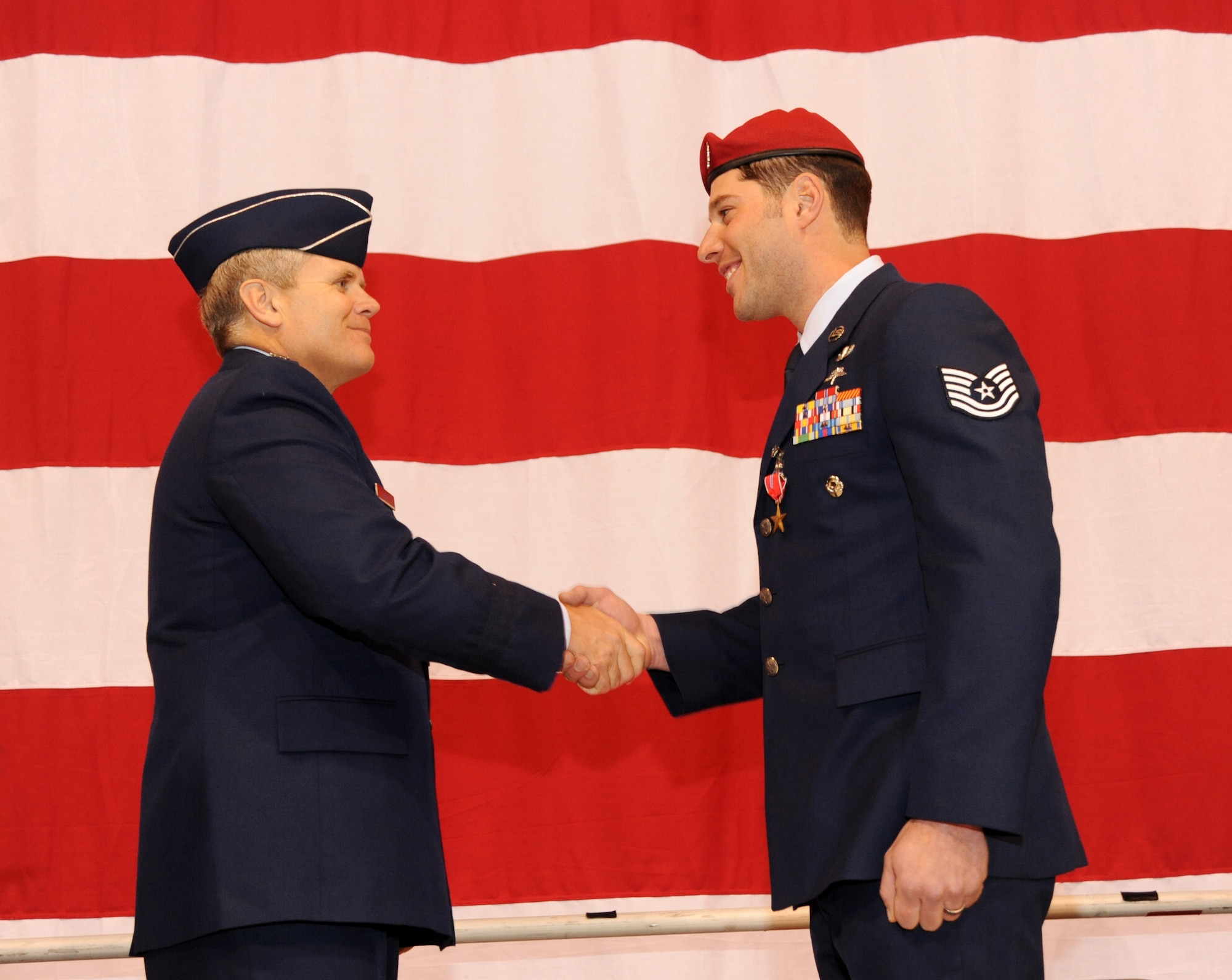 U.S. Air Force Lt. Gen. Eric E. Feil, commander of Air Force Special Operations Command, congratulates Tech. Sgt. Jeffery A. Dozelal of the 125th Special Tactics Squadron after he received his Bronze Star Medal during an award ceremony held at the Portland Air National Guard Base, Portland, Ore., Jan. 23.  The event honored Airmen from the unit with five Bronze Star Medals and one Purple Heart medal.  The Airmen earned the medals during recent deployments to the Middle East. Fiel flew in from AFSOC headquarters at Hulburt Field, Fla., for the ceremony (U.S. Air Force photo by Tech. Sgt. John Hughel, 142nd Fighter Wing Public Affairs/Released))