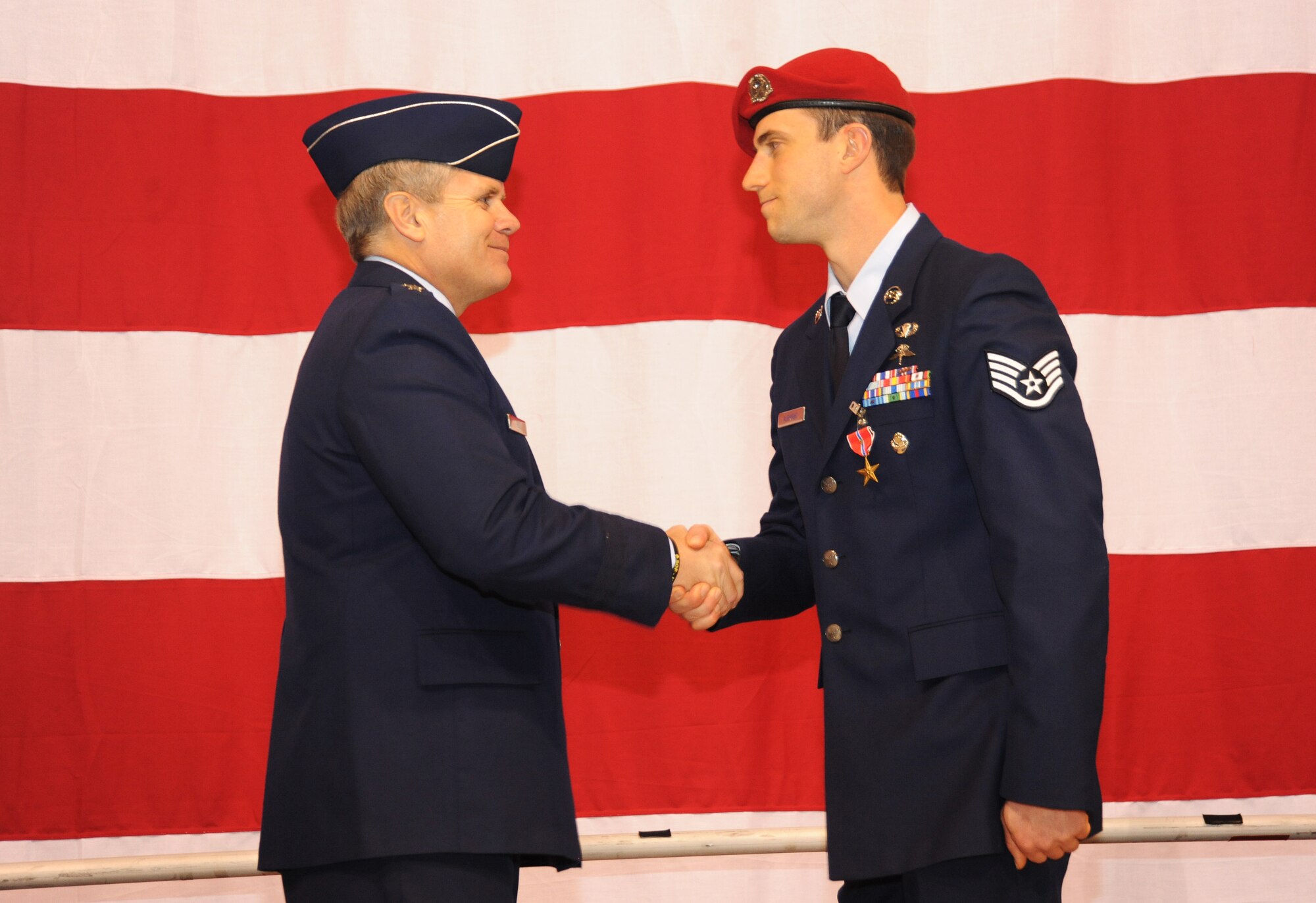 U.S. Air Force Lt. Gen. Eric E. Feil, commander of Air Force Special Operations Command, congratulates Staff Sgt. David A. Algright of the 125th Special Tactics Squadron during an award ceremony held at the Portland Air National Guard Base, Portland, Ore., Jan. 23.  The event honored Airmen from the unit with five Bronze Star Medals and one Purple Heart medal.  The Airmen earned the medals during recent deployments to the Middle East. Fiel flew in from AFSOC headquarters at Hulburt Field, Fla., for the ceremony (U.S. Air Force photo by Tech. Sgt. John Hughel, 142nd Fighter Wing Public Affairs/Released)