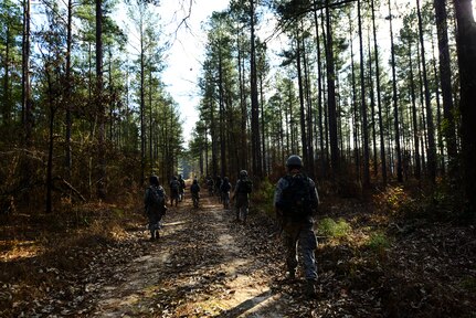 Airmen from the 1st Combat Camera Squadron patrol a road during the Ability to Survive and Operate exercise Jan. 16, 2013, at North Auxiliary Air Field, S.C. Combat Camera held the exercise to train Airmen to function outside the wire as combat documentation specialists. The week-long exercise began Jan. 7 and ended Jan. 18. The 1st CTCS acquires still and motion imagery in support of classified and unclassified air, sea and ground military operations. (U.S. Air Force photo/Senior Airman George Goslin)