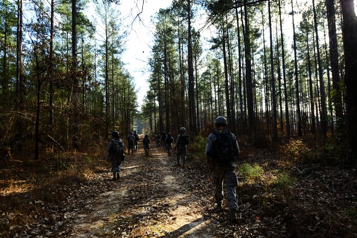 Airmen from the 1st Combat Camera Squadron patrol a road during the Ability to Survive and Operate exercise Jan. 16, 2013, at North Auxiliary Air Field, S.C. Combat Camera held the exercise to train Airmen to function outside the wire as combat documentation specialists. The week-long exercise began Jan. 7 and ended Jan. 18. The 1st CTCS acquires still and motion imagery in support of classified and unclassified air, sea and ground military operations. (U.S. Air Force photo/Senior Airman George Goslin)