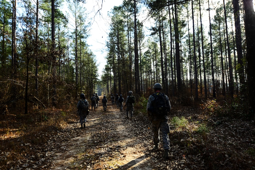 Airmen from the 1st Combat Camera Squadron patrol a road during the Ability to Survive and Operate exercise Jan. 16, 2013, at North Auxiliary Air Field, S.C. Combat Camera held the exercise to train Airmen to function outside the wire as combat documentation specialists. The week-long exercise began Jan. 7 and ended Jan. 18. The 1st CTCS acquires still and motion imagery in support of classified and unclassified air, sea and ground military operations. (U.S. Air Force photo/Senior Airman George Goslin)