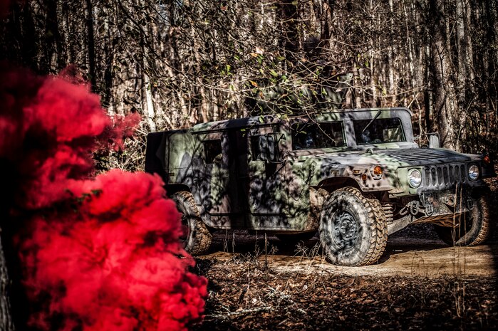 A Humvee drives through an ambush during the Ability to Survive and Operate exercise Jan. 18, 2013, at North Auxiliary Air Field, S.C. Combat Camera held the exercise to train Airmen to function outside the wire as combat documentation specialists. The week-long exercise began Jan. 7 and ended Jan. 18. The 1st CTCS acquires still and motion imagery in support of classified and unclassified air, sea and ground military operations. (U.S. Air Force photo/Senior Airman Dennis Sloan)
