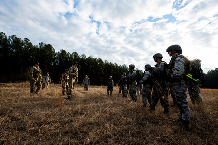 Instructors teach Airmen from the 1st Combat Camera Squadron on tactical movement during the Ability to Survive and Operate exercise Jan. 16, 2013, at North Auxiliary Air Field, S.C. Combat Camera held the exercise to train Airmen to function outside the wire as combat documentation specialists. The week-long exercise began Jan. 7 and ended Jan. 18. The 1st CTCS acquires still and motion imagery in support of classified and unclassified air, sea and ground military operations. (U.S. Air Force photo/Senior Airman George Goslin)