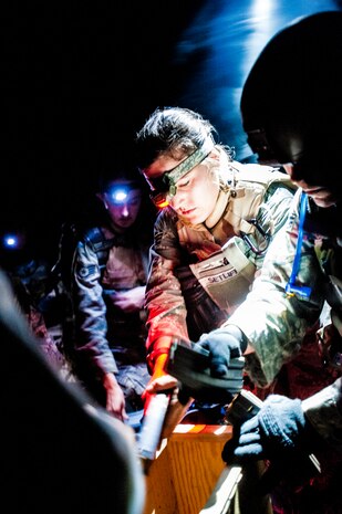 Senior Airman Angela Setliff, 1st Combat Camera Squadron broadcaster, unloads ammunition into an ammo crate during the Ability to Survive and Operate exercise Jan. 16, 2013, at North Auxiliary Air Field, S.C. Combat Camera held the exercise to train Airmen to function outside the wire as combat documentation specialists. The week-long exercise began Jan. 7, 2013, and ended Jan. 18. The 1st CTCS acquires still and motion imagery in support of classified and unclassified air, sea and ground military operations. (U.S. Air Force photo/Senior Airman Dennis Sloan)